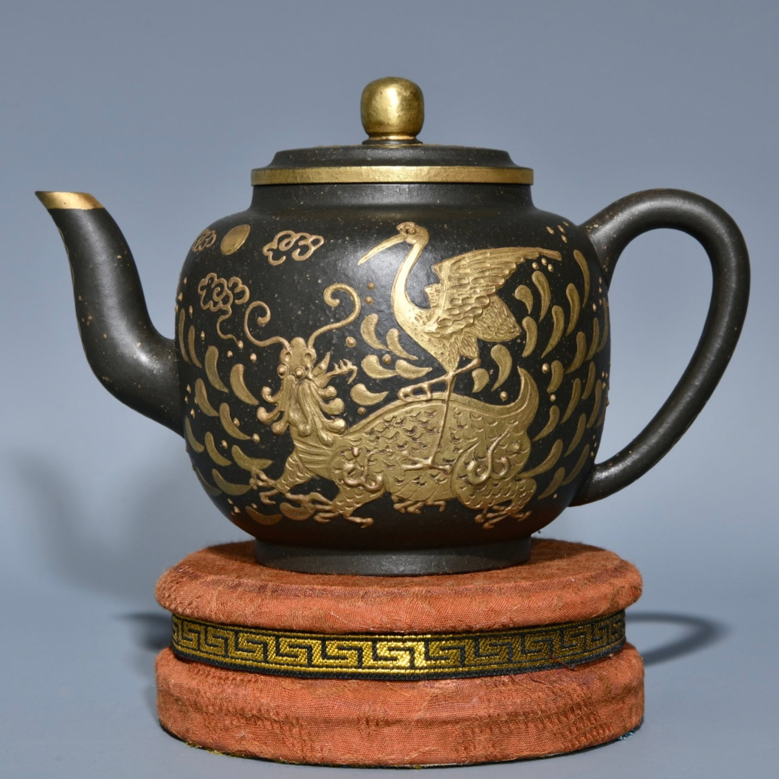 An Exquisite Purple Sands Gilt Flower and Crane Pattern Teapot: An Exquisite Purple Sands Gilt Flower and Crane Pattern Teapot,Qing Dynasty,China,Kangxi Four-character Mark,Size:4.6inx4.1in