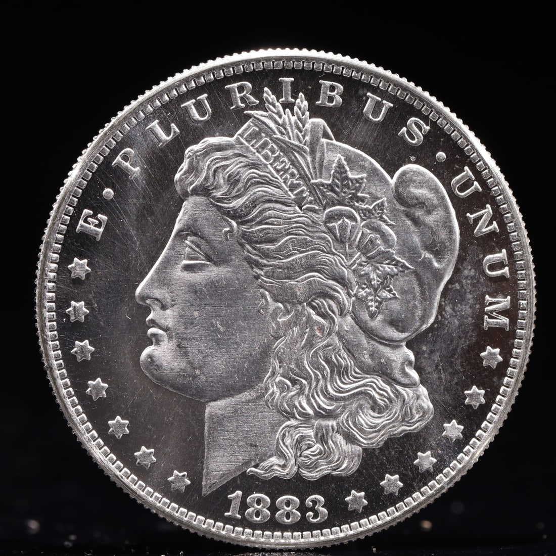 USA Morgan Dollar 1883 Coin: Obv: profile bust with date below and E PLURIBUS UNUM legend and stars around. Rev: eagle with In God we trust above within wreath with UNITED STATES OF AMERICA ONE DOLLAR legend. IN GOD WE TRUST / LI