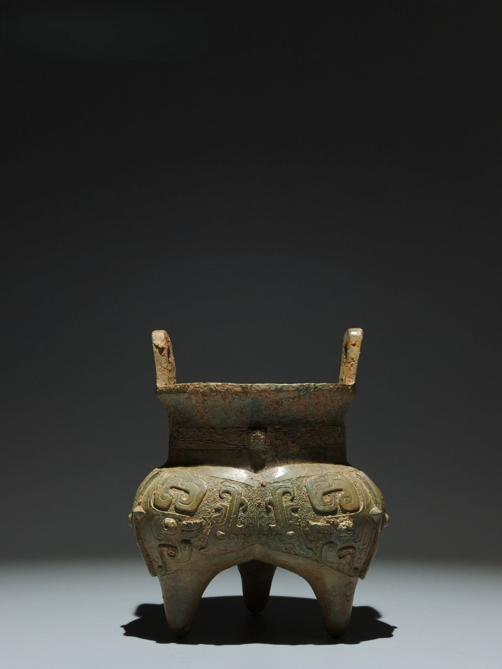 An Archaic Bronze Beast-Face Pattern Double-Ears and Tripod Censer: An Archaic Bronze Beast-Face Pattern Double-Ears and Tripod Censer,Shang Dynasty,China,Size:6.7inx5.5in 青铜兽面纹双耳三足香炉,中