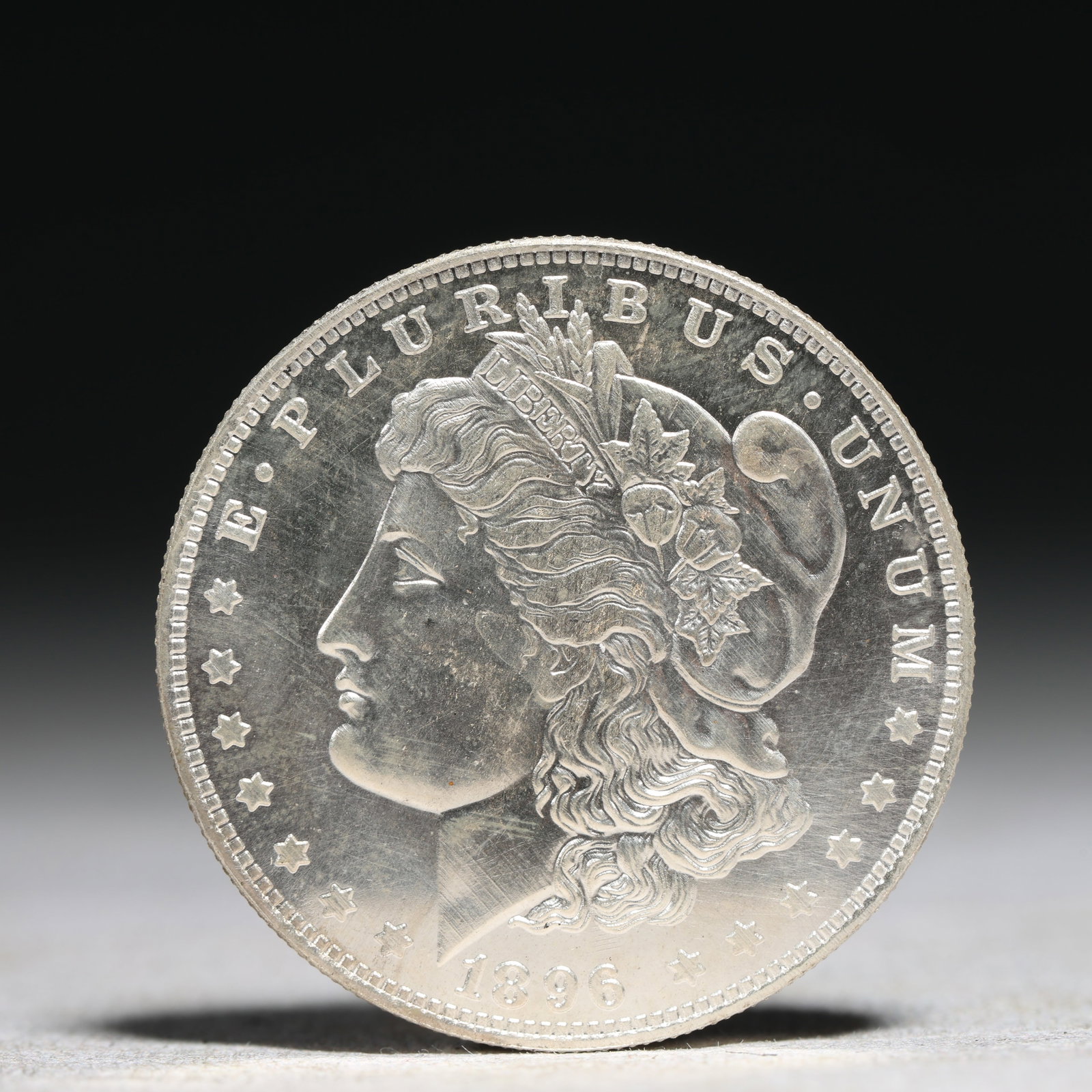 USA Morgan Dollar 1896 Coin: Obv: profile bust with date below and E PLURIBUS UNUM legend and stars around. Rev: eagle with In God we trust above within wreath with UNITED STATES OF AMERICA ONE DOLLAR legend. IN GOD WE TRUST / LI