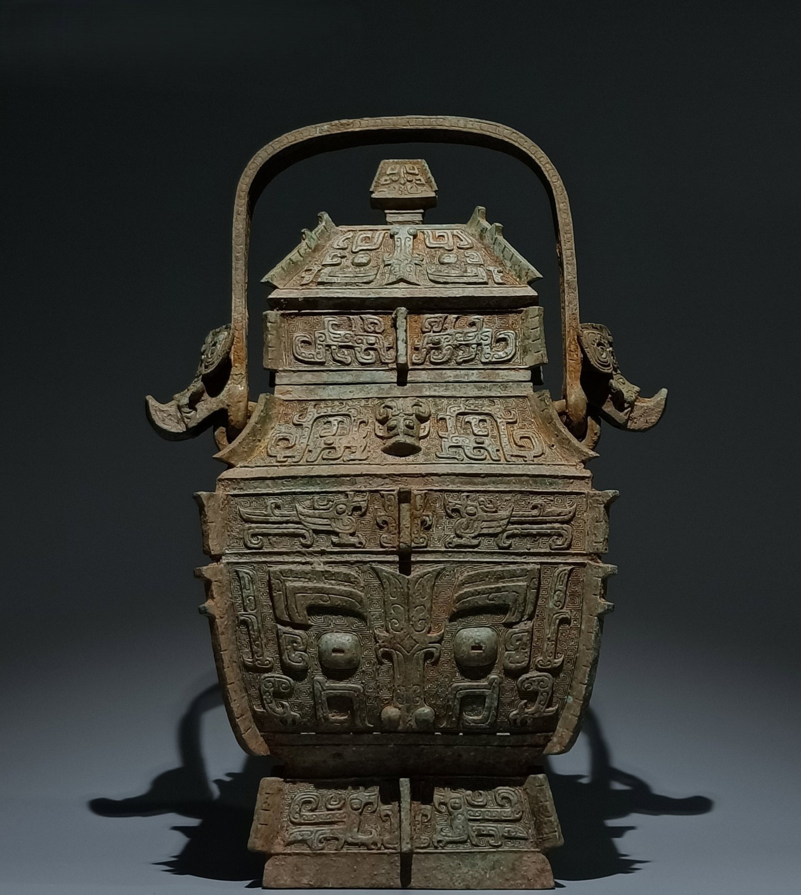 An Archaic Bronze Beast-Face Pattern Loop-Handled Jar: An Archaic Bronze Beast-Face Pattern Loop-Handled Jar,Shang Dynasty,China,Size:18.5inx9.1inx8.3in 青铜兽面纹提梁罐,中国商代