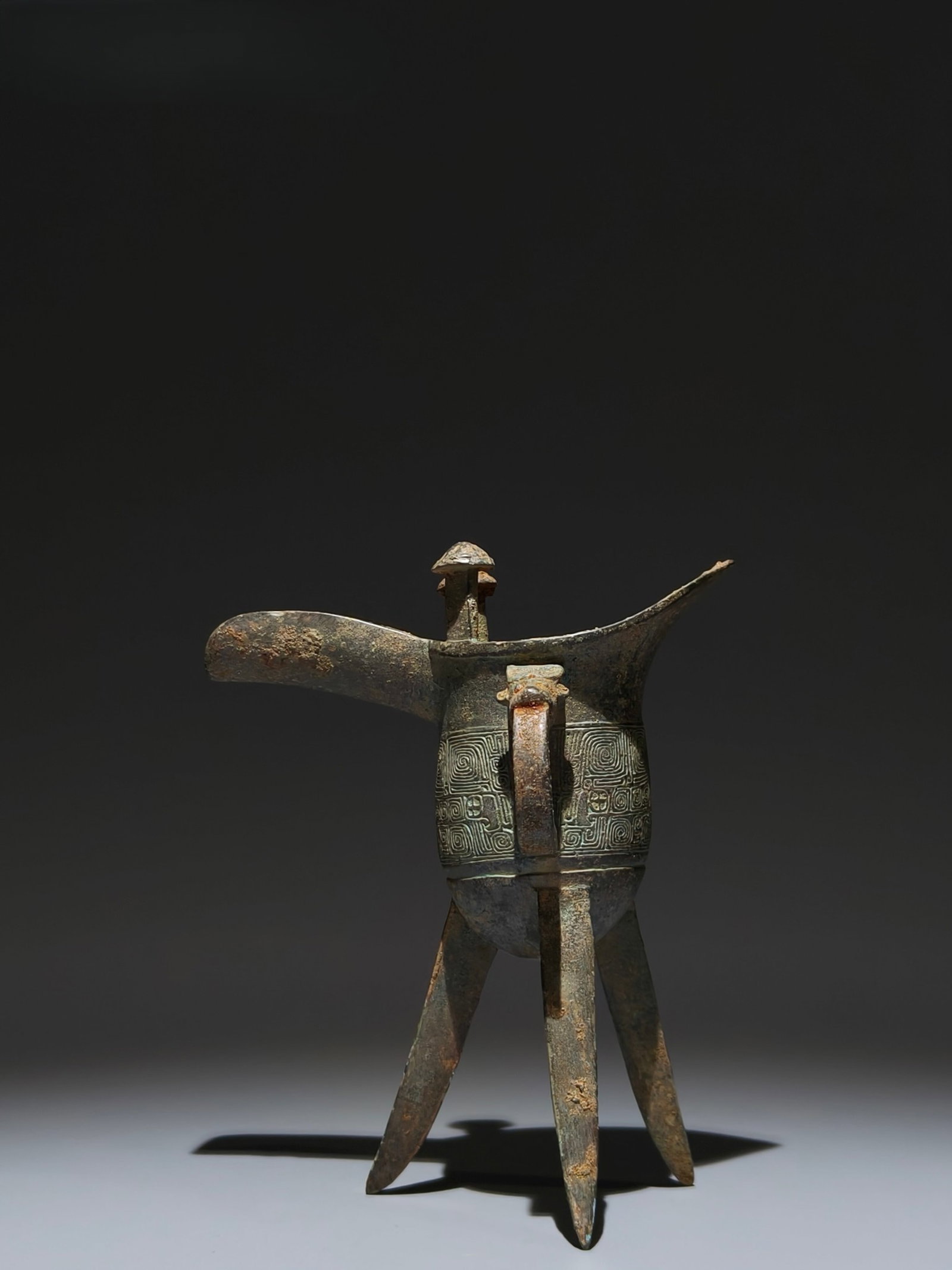 An Archaic Bronze Auspicious Cloud Pattern Tripod Cup: An Archaic Bronze Auspicious Cloud Pattern Tripod Cup,the Warring States period in China,Size:7.1inx5.9inx3.5in
