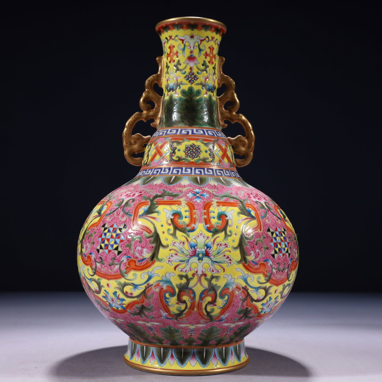 An Exquisite Yellow Ground Famille-Rose Painted Gold Lotus Pattern Double-Ears Vase: An Exquisite Yellow Ground Famille-Rose Painted Gold Lotus Pattern Double-Ears Vase,Qing Dynasty,China,Qianlong Six-character Mark,Size:7.5inx13.4in,Weight:2550g 黄地粉彩৻