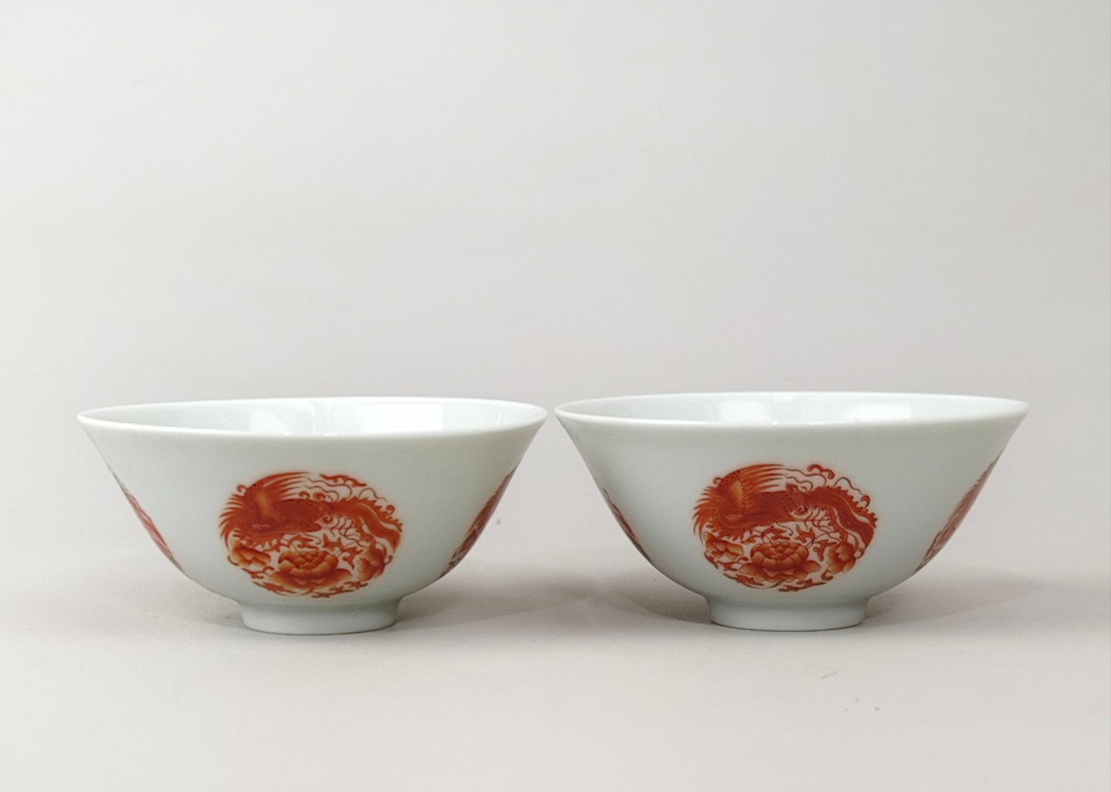 A Pair of Exquisite Iron-Red Flower and Phoenix Pattern Cups: A Pair of Exquisite Iron-Red Flower and Phoenix Pattern Cups,Qing Dynasty,China,Yongzheng Four-character Mark,Size:1.7inx3.6in 一对矾红花卉凤纹杯&