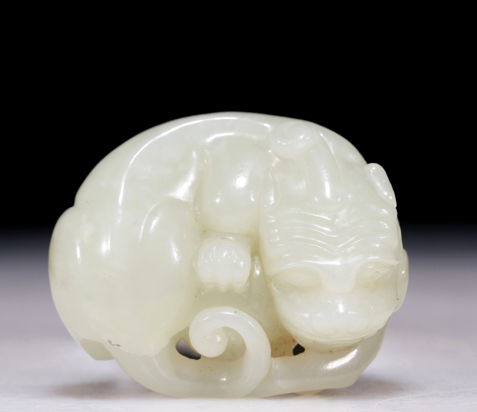 An Excellent White Jade Auspicious Beast: An Excellent White Jade Auspicious Beast. Carved with a scrolling tail. Chinese Qing Dynasty. Size:1.8inx1.5inx0.8in 清代 白玉瑞兽手把件