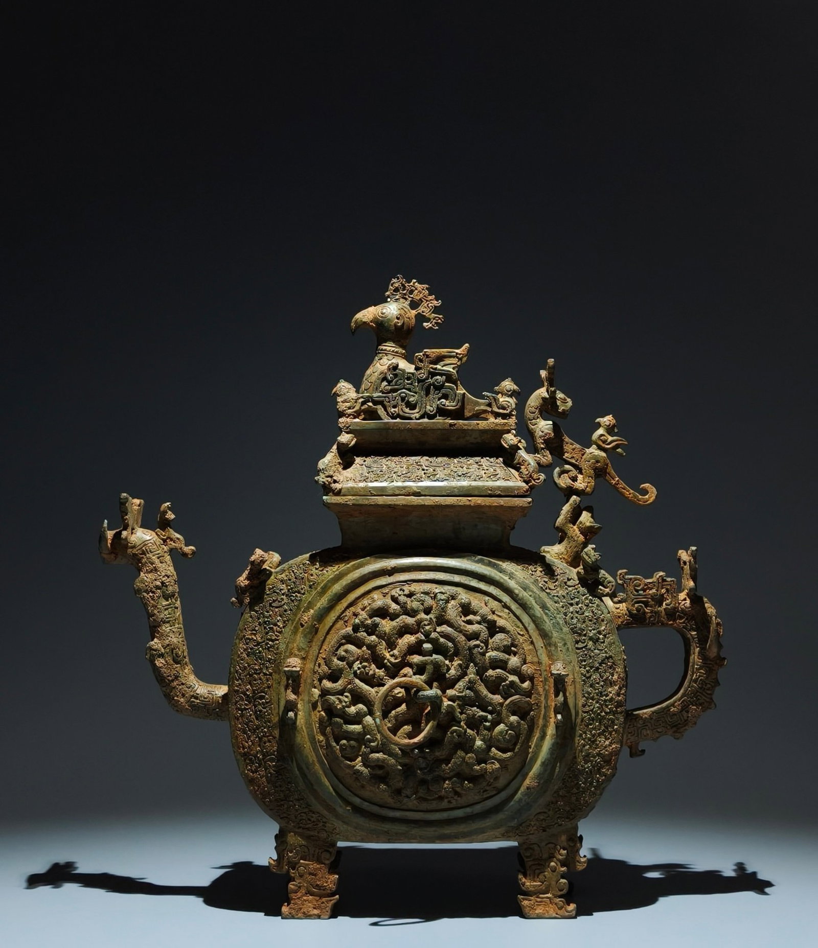 An Archaic Bronze Coiled-Dragon Pattern Dragon-head Food Vessel,With Phoenix Cover: An Archaic Bronze Coiled-Dragon Pattern Dragon-head Food Vessel,With Phoenix Cover,the Spring and Autumn in Period in China,Size:16.1inx15.4inx5.1in 青铜蟠龙纹龙