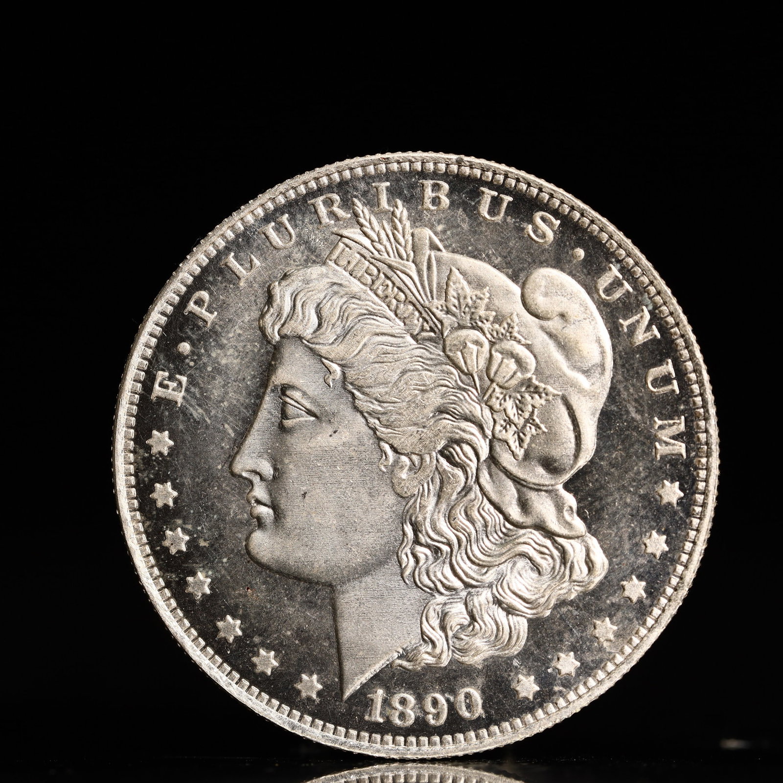 USA Morgan Dollar 1890 Coin: Obv: profile bust with date below and E PLURIBUS UNUM legend and stars around. Rev: eagle with In God we trust above within wreath with UNITED STATES OF AMERICA ONE DOLLAR legend. IN GOD WE TRUST / LI