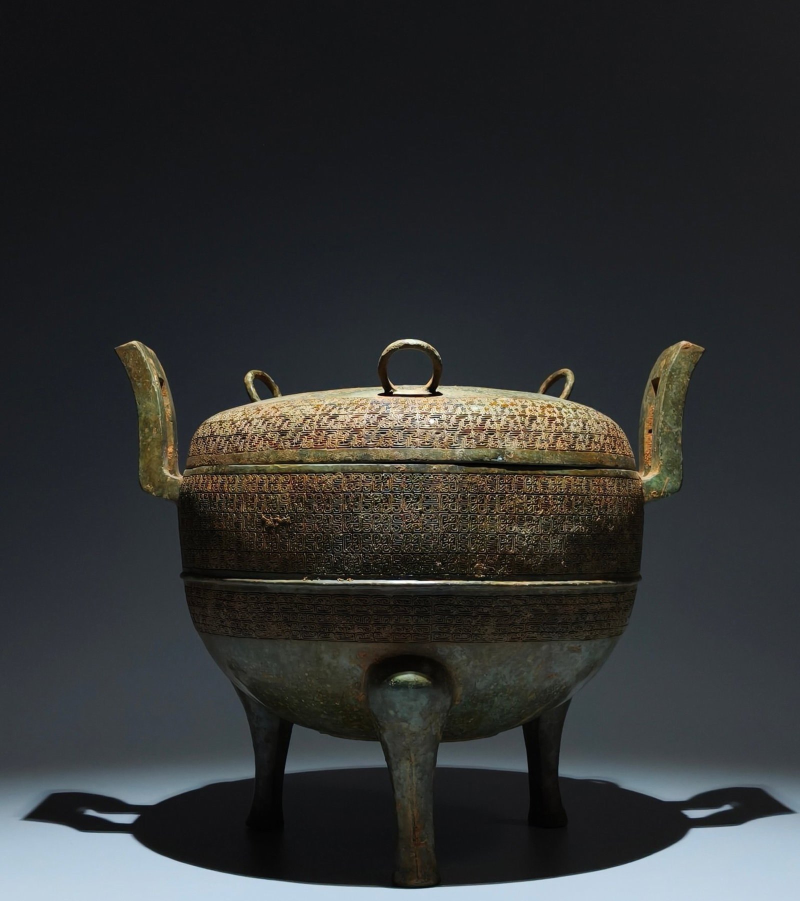 An Archaic Bronze Cloud and Thunder Pattern Double-Ears Tripod Censer,With Inscription: An Archaic Bronze Cloud and Thunder Pattern Double-Ears Tripod Censer,With Inscription,the Warring States period in China,Size:11.8inx14inx10.8in 青铜云雷纹双೑