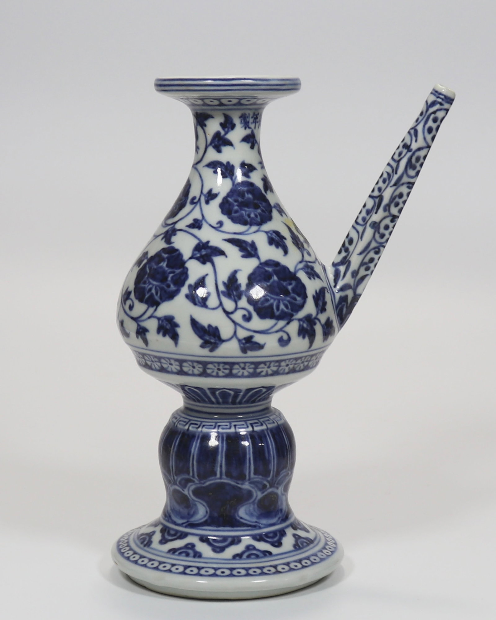 A fine blue and white kundika ewer with scrolling peony pattern: A fine blue and white kundika ewer with scrolling peony pattern, Ming Dynasty, China, with six-character Xuande reign mark, Size:9in 青花缠枝牡丹纹军