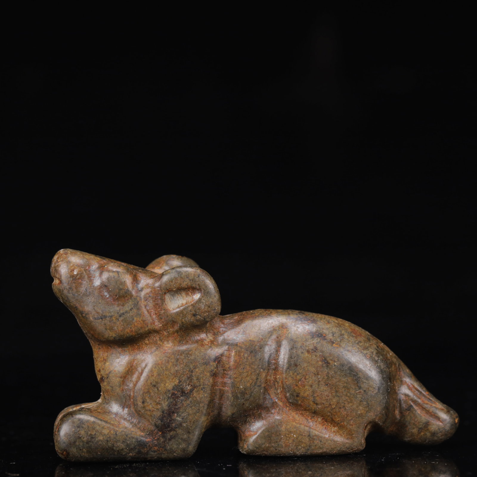 A Pair of Exquisite Gongxian yao Beast Ornaments: A small yellow jade carving of a recumbent beast of simplified form, the stone of warm yellowish tone with a smooth polish. An important example of early Chinese jade carving from the Hongshan
