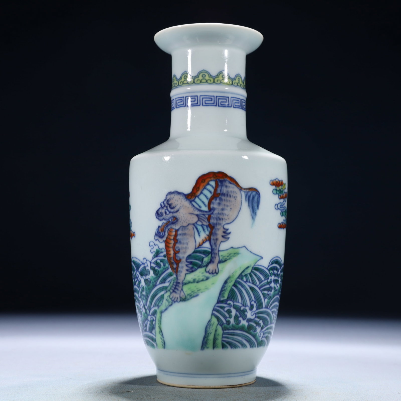 A Set of Fine Gilt Bronze Dragon Seals: The vase delicately painted in underglaze blue with outlines filled in bright enamels with a leaping lion amongst crashing waves. The base with a six-character Yongzheng mark.