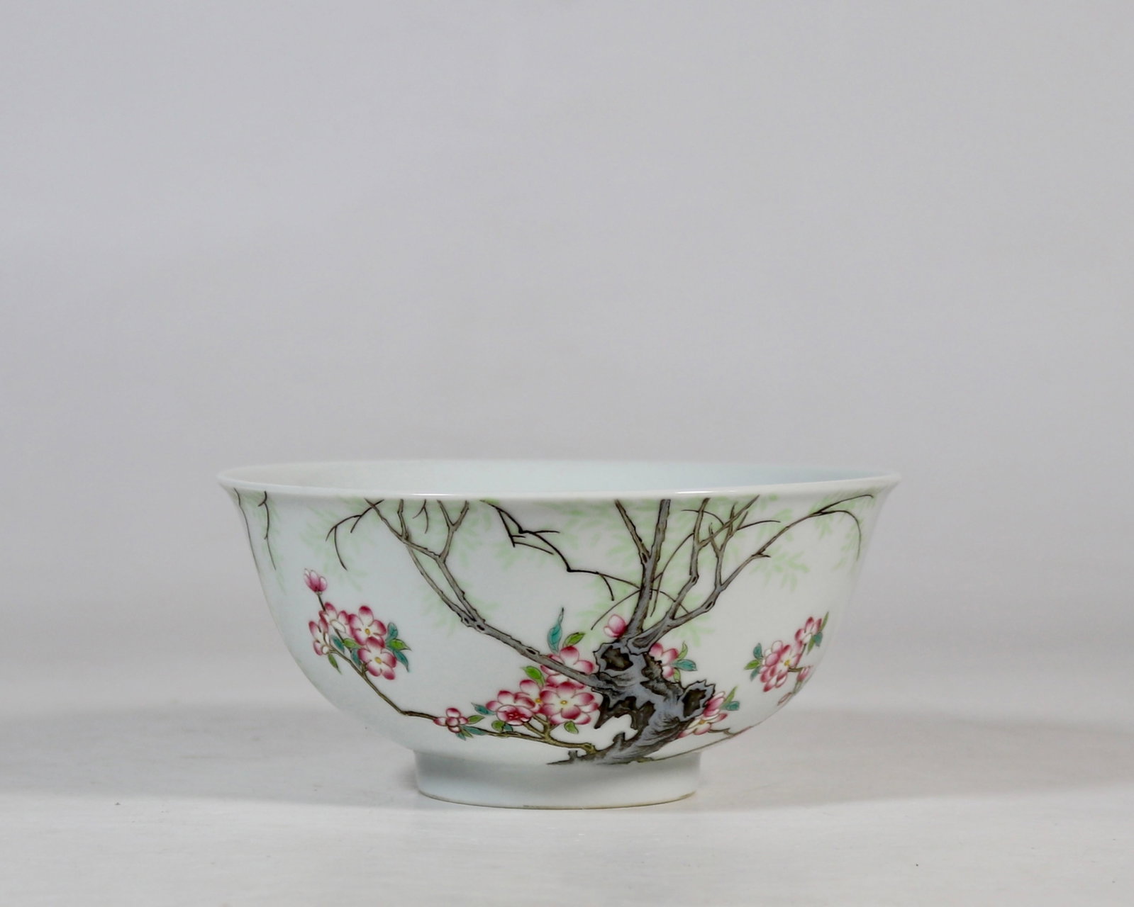 A Chinese Vertical Scroll Ink Painting of Landscape on Paper: A fine falangcai bowl with swallows in apricot forest spring scene, Qing Dynasty, China, with six-character Qianlong reign mark, Size:2.8inx5.9inA fine falangcai bowl with swallows in apricot forest