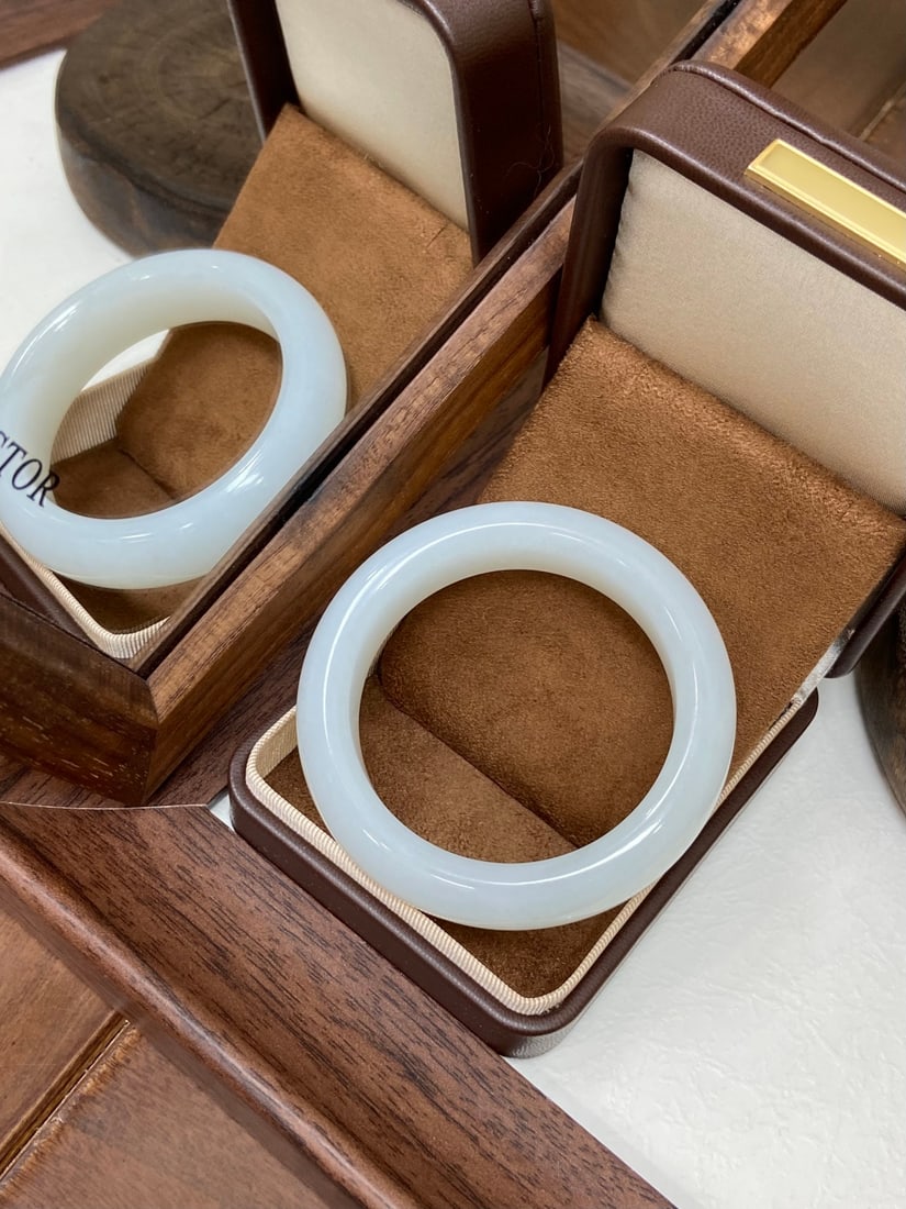 A Set of Fine Ruby Red-Glazed Enamel Flower and Fruit Pattern Stem Cups: A fine collection of Hetian jade bangles of Tiantai origin, each of white tone, of fine, oily texture with a warm, glutinous luster. The bangles exhibit the finest oiliness and jadeification, close to