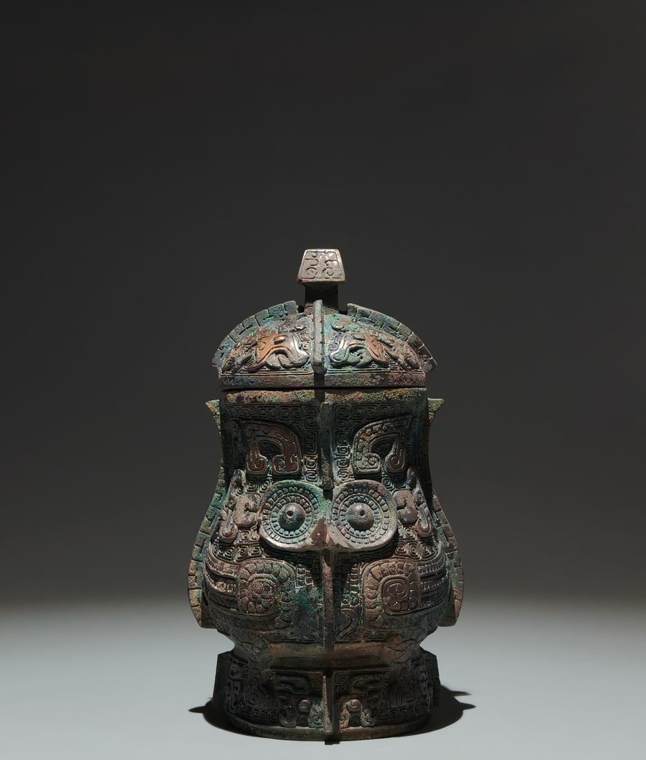 An Exquisite Blue and White Auspicious Cloud and Dragon Pattern Vase: An Archaic Bronze Beast-Face Pattern Libation Cup,W.Zhou,China,Size:7.3inx3.9inx3.7in 青铜兽面纹酒杯,中国西周时期