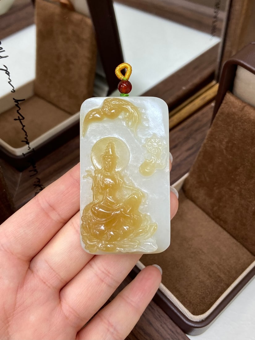 A Pair of Exquisite Yellow Jade Deer Ornaments: A finely carved Hetian jade plaque of Qiemo origin, of sugary-white tone, carved with a phoenix and a seated Guanyin, symbolizing protection and prosperity. The jade is of fine, even texture with a ri