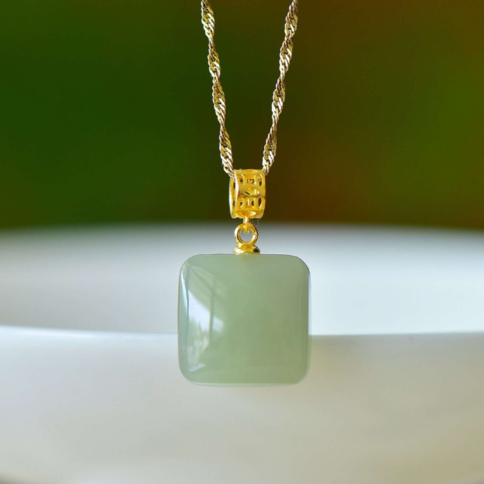 An Exquisite Sterling Silver-Gold Plated Inlaid Greenish Jade Pendant: An Exquisite Sterling Silver-Gold Plated Inlaid Greenish Jade Pendant,Size:0.6inx0.6in 纯银镀金镶青玉吊坠