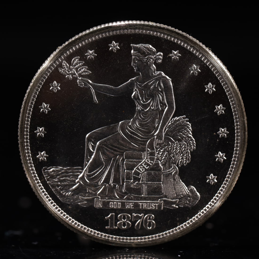 USA Trade Dollar 1876 Coin: American coin. Obverse: Liberty seated on a pedestal facing the sea to the left holding olive branches surrounded by 13 stars. IN GOD WE TRUST / LIBERTY / 1876. Reverse: An eagle holding branches with