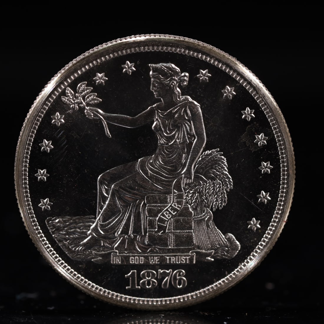 USA Trade Dollar 1876 Coin: American coin. Obverse: Liberty seated on a pedestal facing the sea to the left holding olive branches surrounded by 13 stars. IN GOD WE TRUST / LIBERTY / 1876. Reverse: An eagle holding branches with