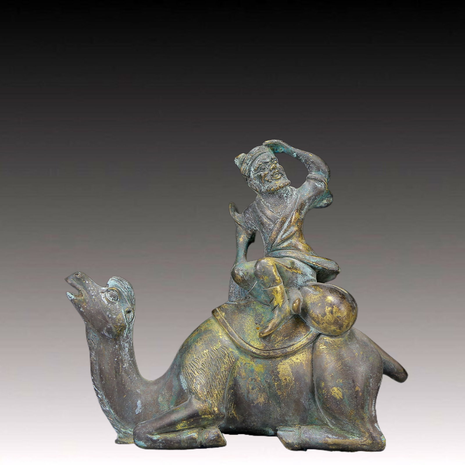 A Solemn Gilt Bronze Figure Riding Camel Ornament: A Solemn Gilt Bronze Figure Riding Camel Ornament,Ming Dynasty, China,Size:6.3inx2.4inx5.9in,Weight:1070g 铜鎏金人物骑骆驼摆件，਴