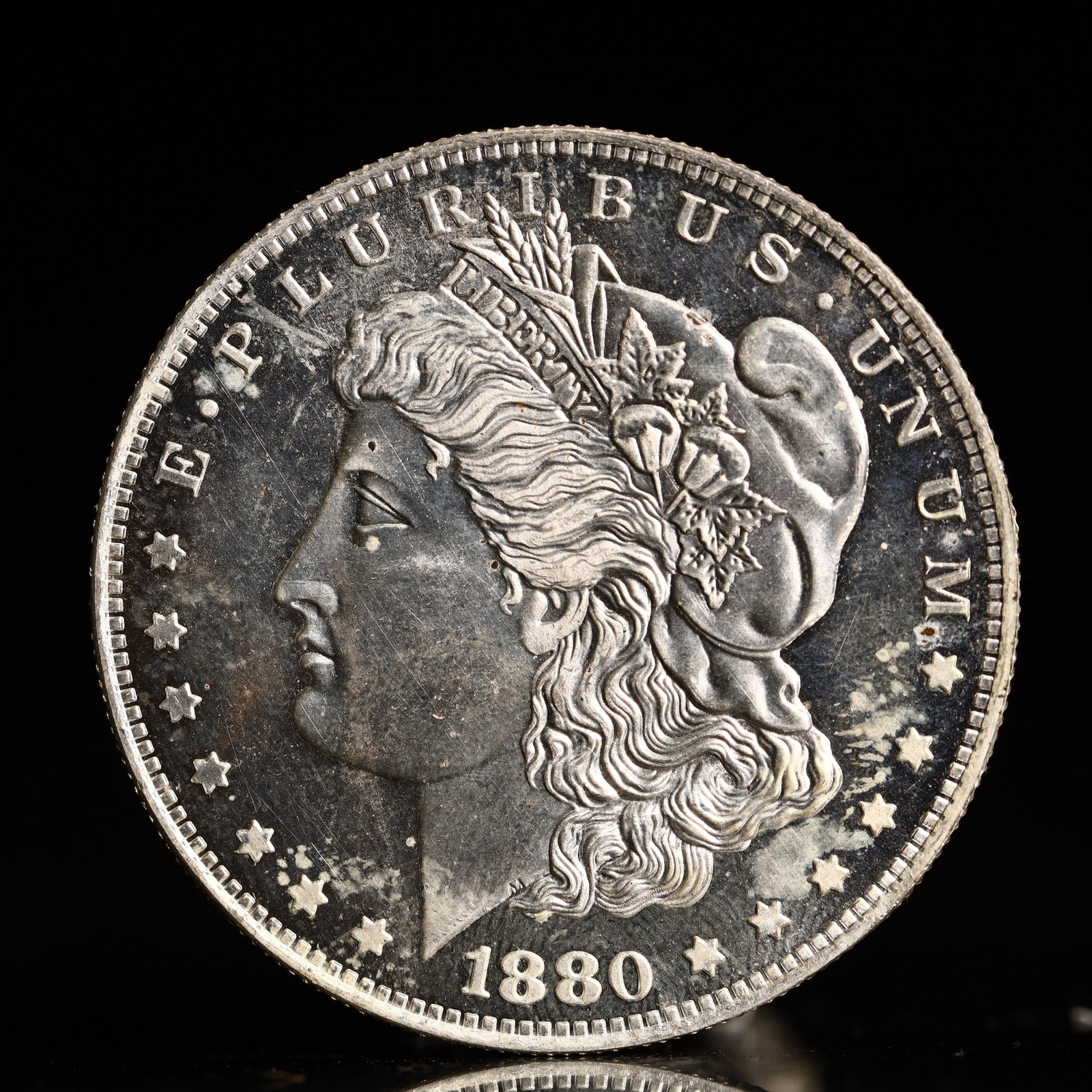 USA Morgan Dollar 1880 Coin: Obv: profile bust with date below and E PLURIBUS UNUM legend and stars around. Rev: eagle with In God we trust above within wreath with UNITED STATES OF AMERICA ONE DOLLAR legend. IN GOD WE TRUST /