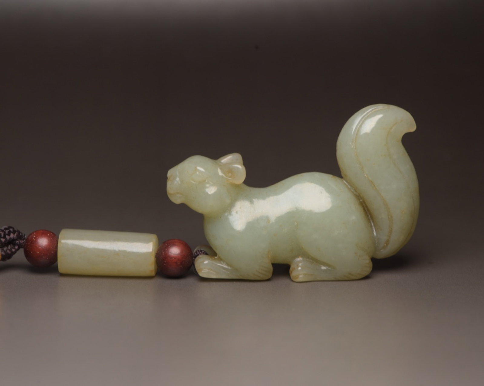 An Exquisite White Jade Squirrel Ornament: An Exquisite White Jade Squirrel Ornament,Qing Dynasty,China,Size:3.3inx1.5inx0.6in,Weight:40g 白玉松鼠摆件,中国清代