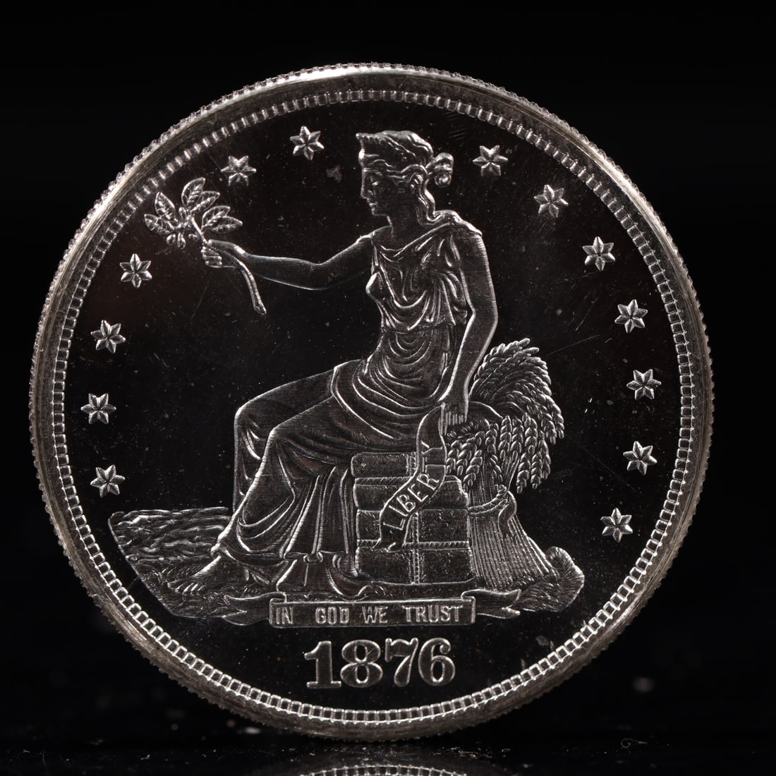 USA Trade Dollar 1876 Coin: American coin. Obverse: Liberty seated on a pedestal facing the sea to the left holding olive branches surrounded by 13 stars. IN GOD WE TRUST / LIBERTY / 1876. Reverse: An eagle holding branches with