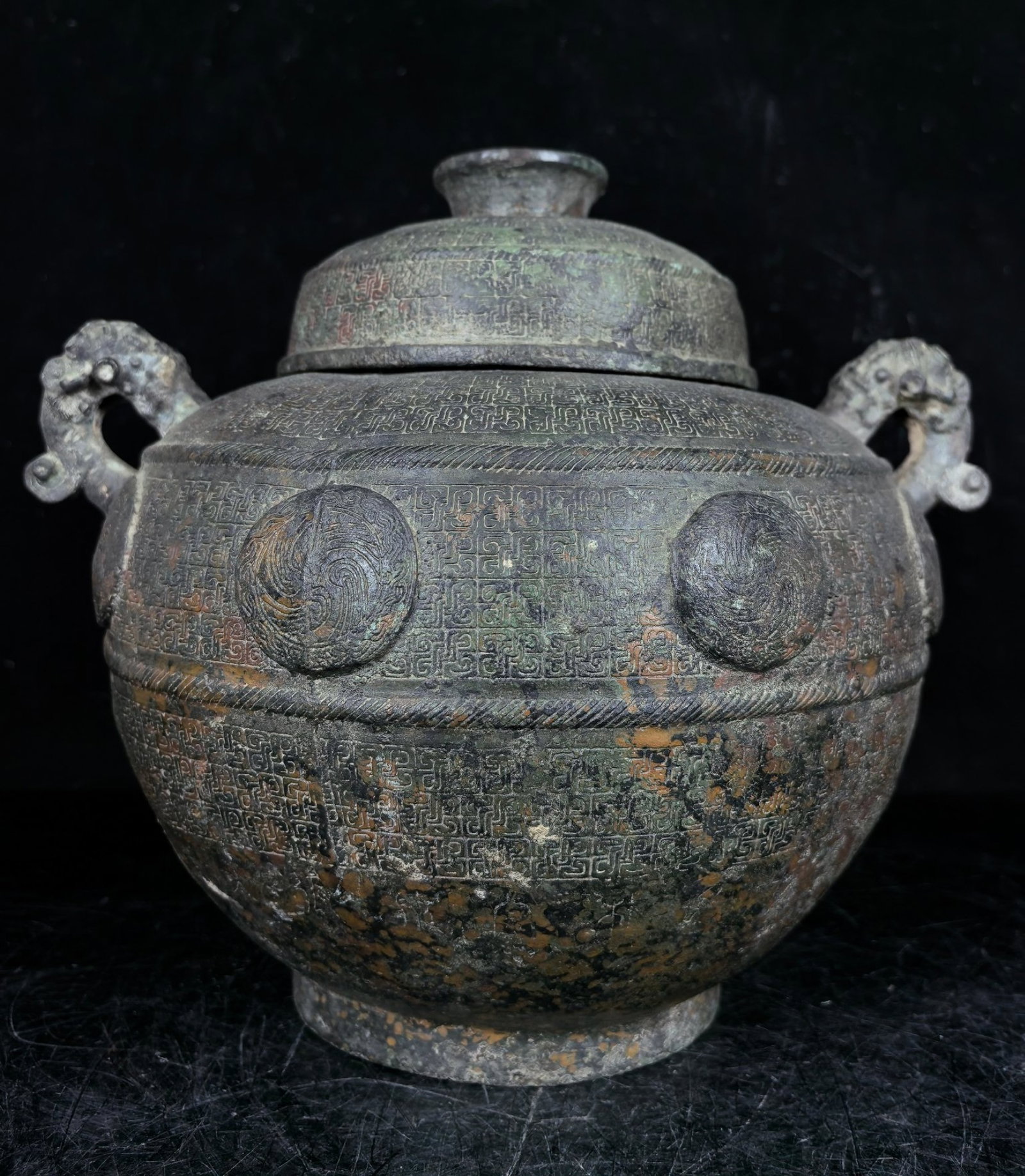 An Archaic Bronze Beast-Ears Food Vessel: An Archaic Bronze Beast-Ears Food Vessel,the Warring States period in China,Size:9.1inx10.6inx8.3in,Weight:3.25kg 中国春秋战国时期圆涡ಬ