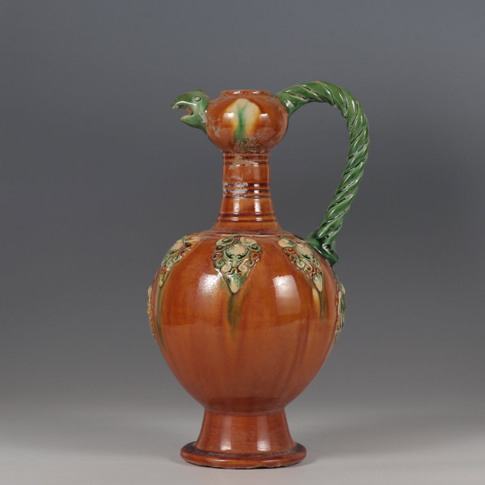 A Rare Tang Tri-Color Glazed Pottery Flower Pattern Phoenix Pot: A Rare Tang Tri-Color Glazed Pottery Flower Pattern Phoenix Pot,Tang Dynasty,China,Size:11.8inx5.5in 唐三彩花卉纹凤壶,中国唐代