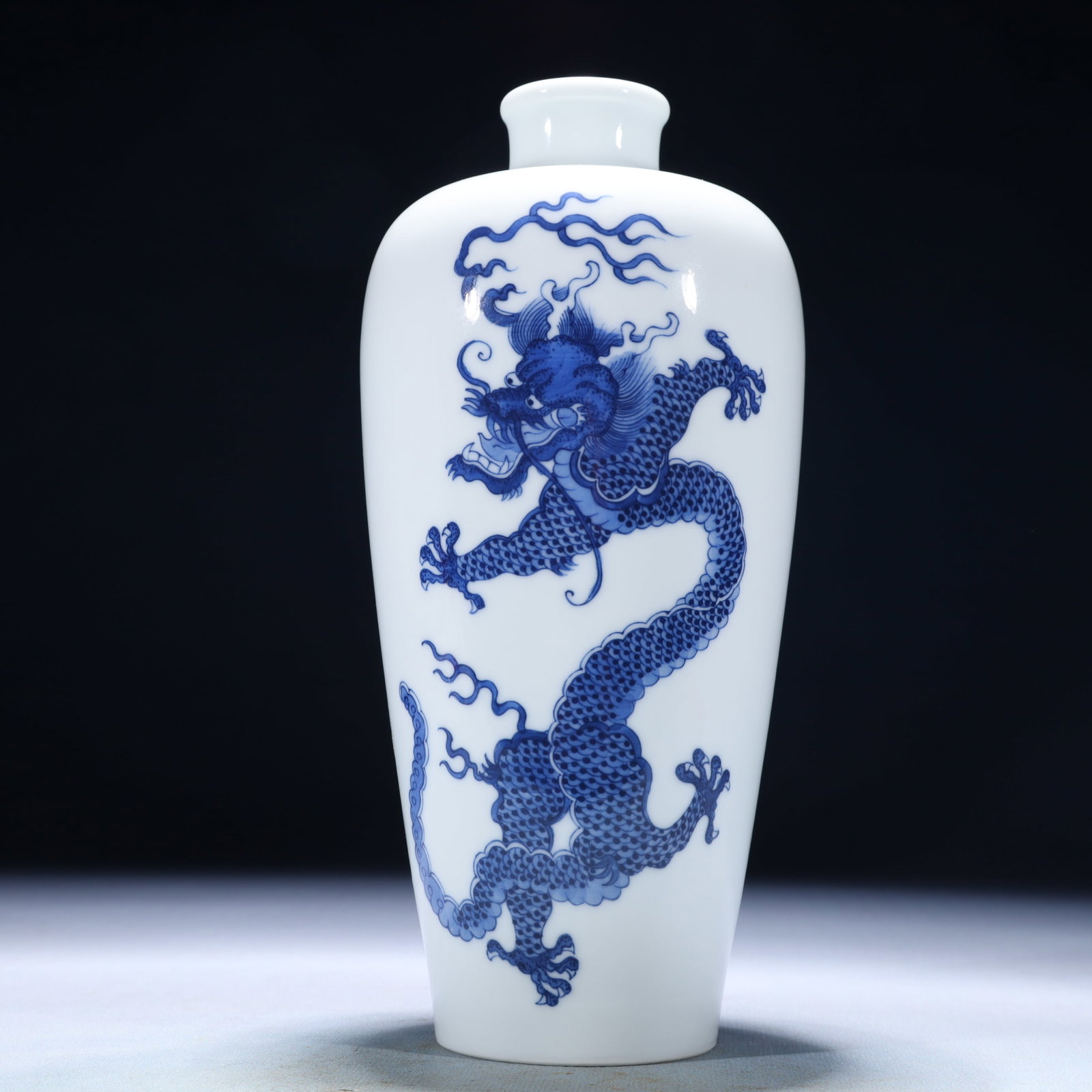 An Exquisite Blue and White Auspicious Cloud and Dragon Pattern Vase: An Exquisite Blue and White Auspicious Cloud and Dragon Pattern Vase,Modern Time of China,Size:3.5inx8.7in,Weight:850g 青花祥云龙纹瓶,中国近
