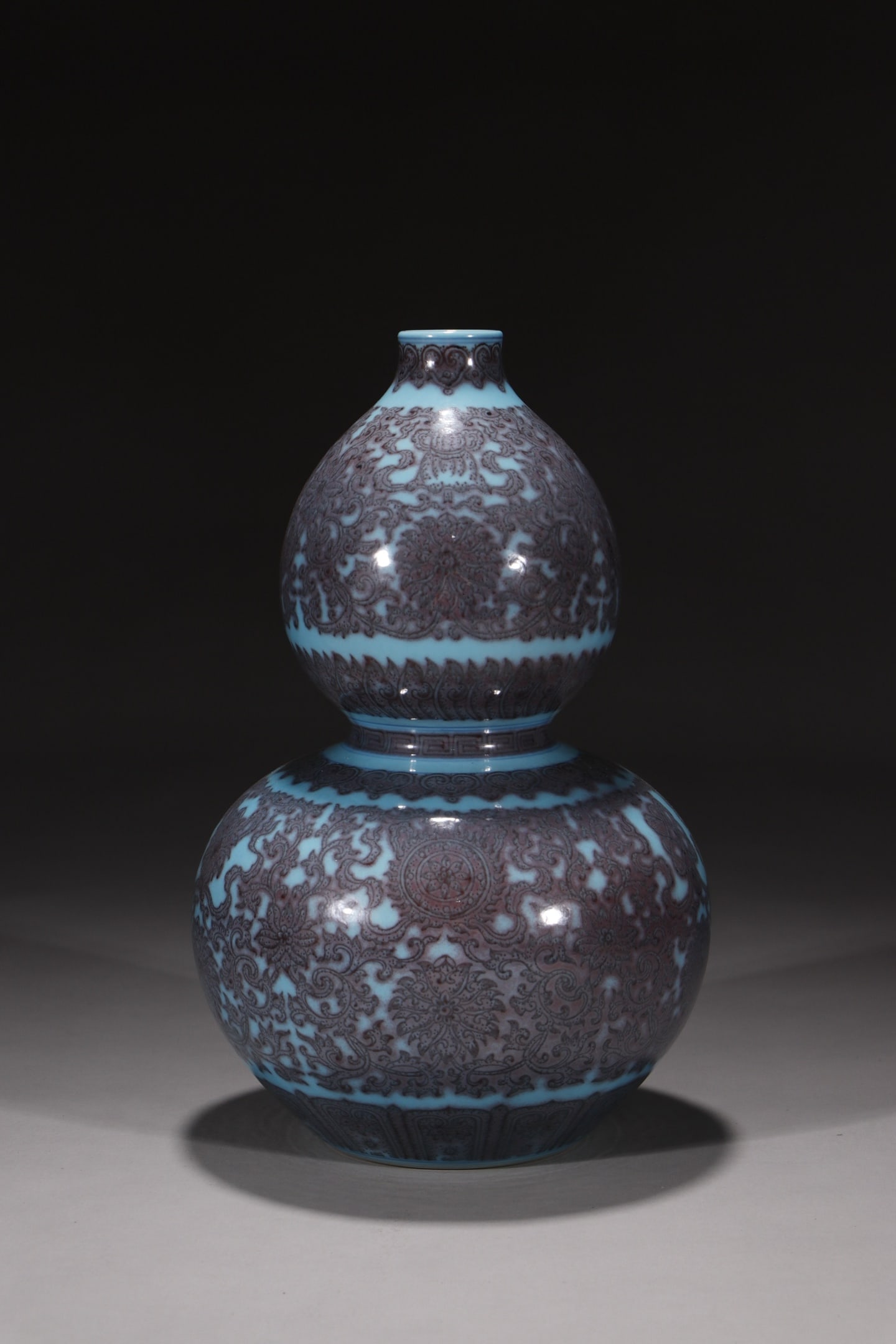 An Exquisite Green Ground Underglaze-Red Lotus and Eight Treasures Pattern Gourd Vase: An Exquisite Green Ground Underglaze-Red Lotus and Eight Treasures Pattern Gourd Vase,Qing Dynasty,China,Qianlong Six-character Mark,Size:11.4in 绿地釉里红缠枝