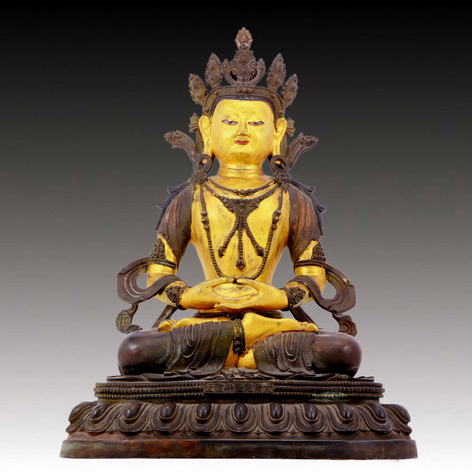 A solemn gilt bronze statue of Bodhisattva: A solemn gilt-bronze Bodhisattva statue, Qianlong seven-character inscription, Qing Dynasty, China. The Bodhisattva's posture is graceful and peaceful. His face is solemn and kind, and his eyes are