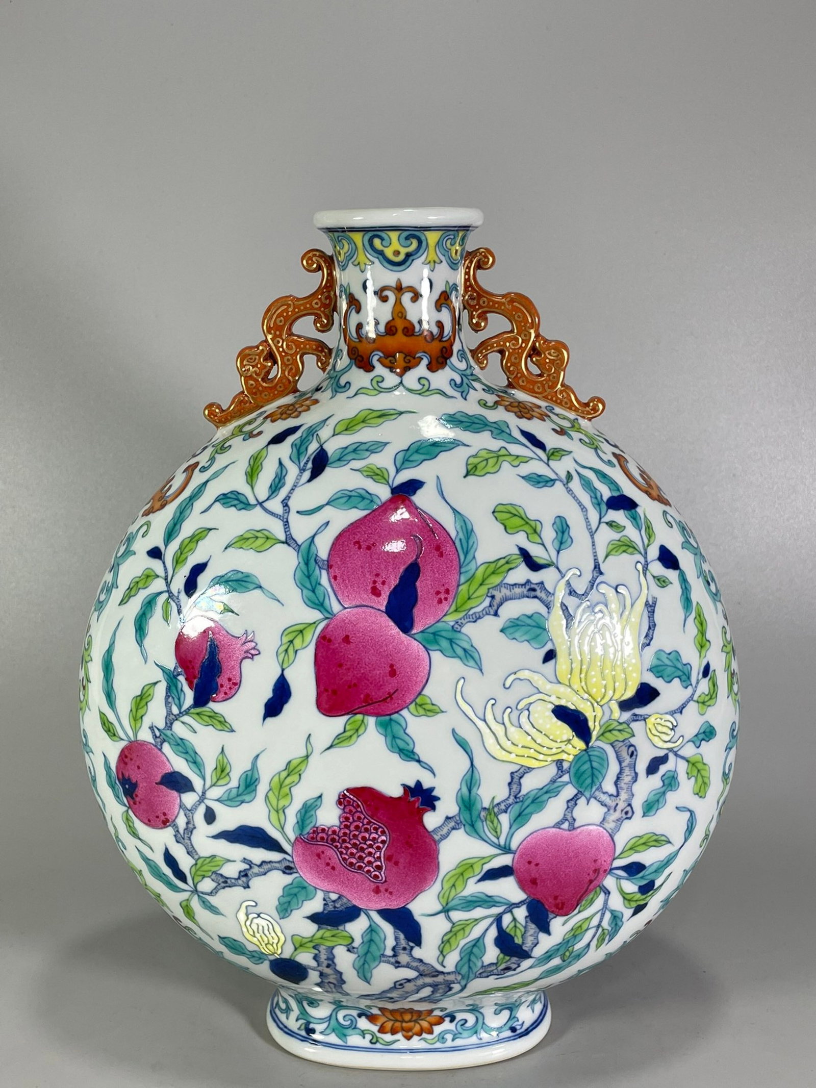 A Rare Doucai Flower and Fruit Pattern Double-Ears Vase: A Rare Doucai Flower and Fruit Pattern Double-Ears Vase,Qing Dynasty,China,Qianlong Six-character Mark,Size:12.7inx10in 斗彩花果纹双耳瓶,中国