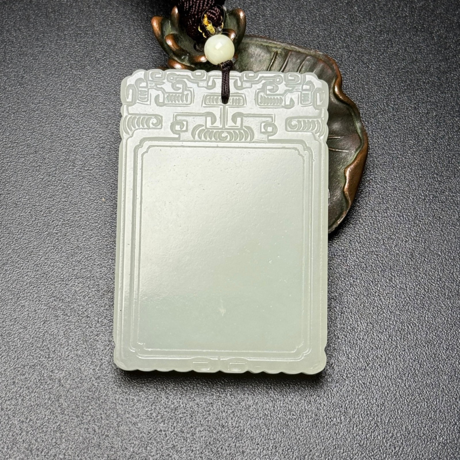An Exquisite White Jade Pendant: An Exquisite White Jade Pendant,Qing Dynasty,China,Size:2.3inx1.6inx0.3in,Weight:57g 白玉牌,中国清代