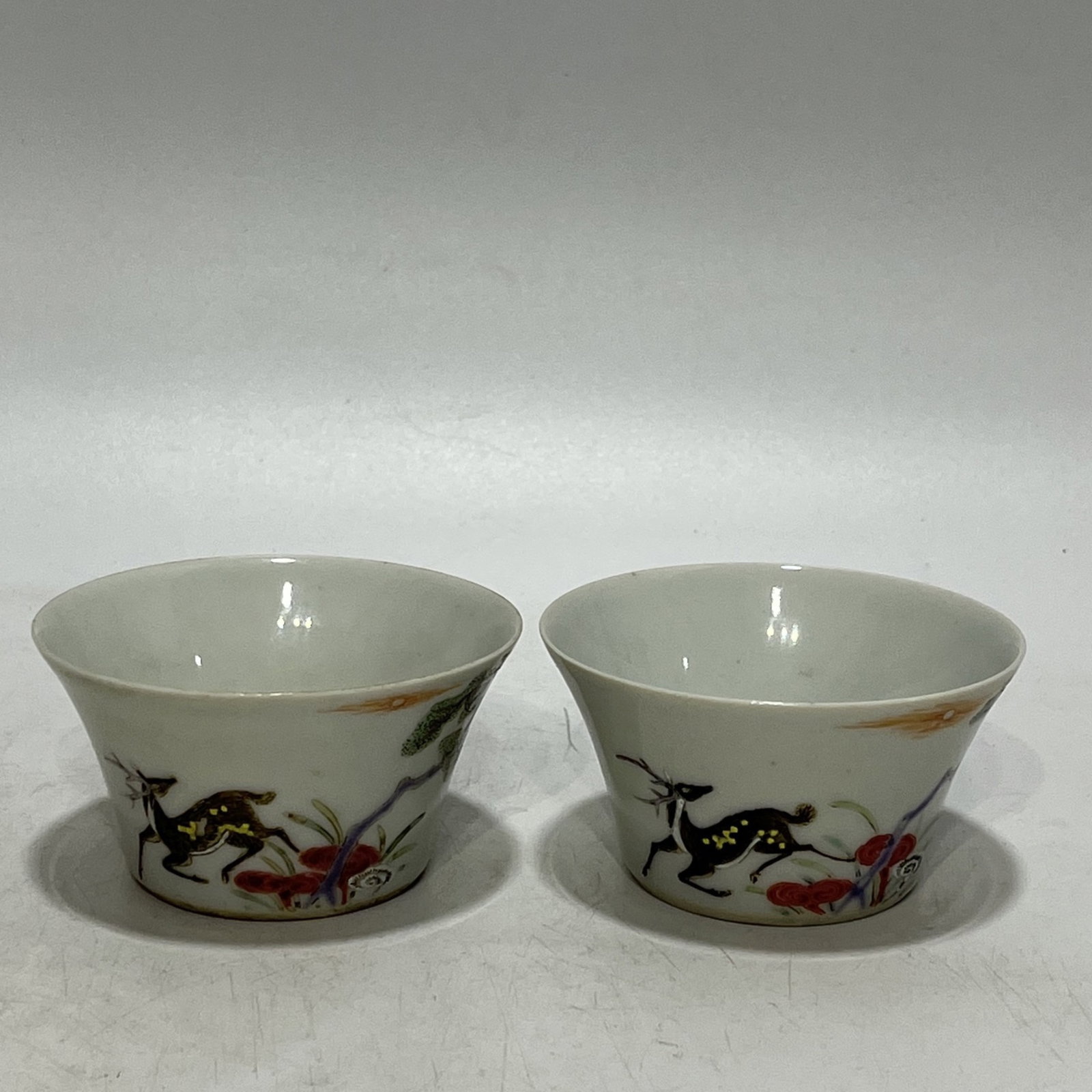 A Pair of Exquisite Famille-Rose Pine,Deer and Crane Pattern Cups: A Pair of Exquisite Famille-Rose Pine,Deer and Crane Pattern Cups,Qing Dynasty,China,Yongzheng Six-character Mark,Size:3.1in 一对粉彩松鹿鹤纹杯,&#