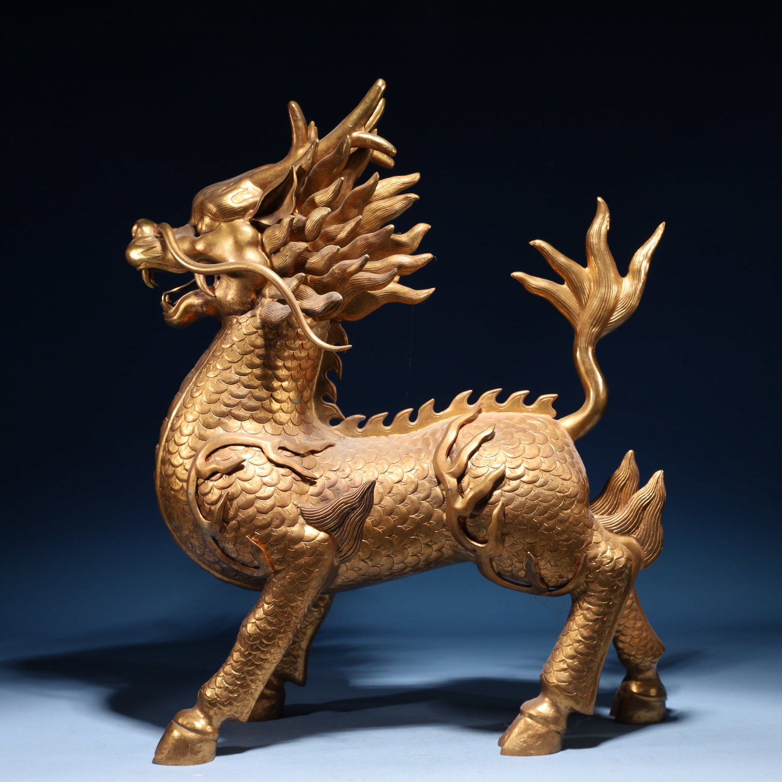 An Exquisite Gilt Bronze Kylin Ornament: An Exquisite Gilt Bronze Kylin Ornament,Qing Dynasty,China,Size:15.7inx7.1inx19.7in,Weight:15700g 铜鎏金麒麟摆件,中国清代