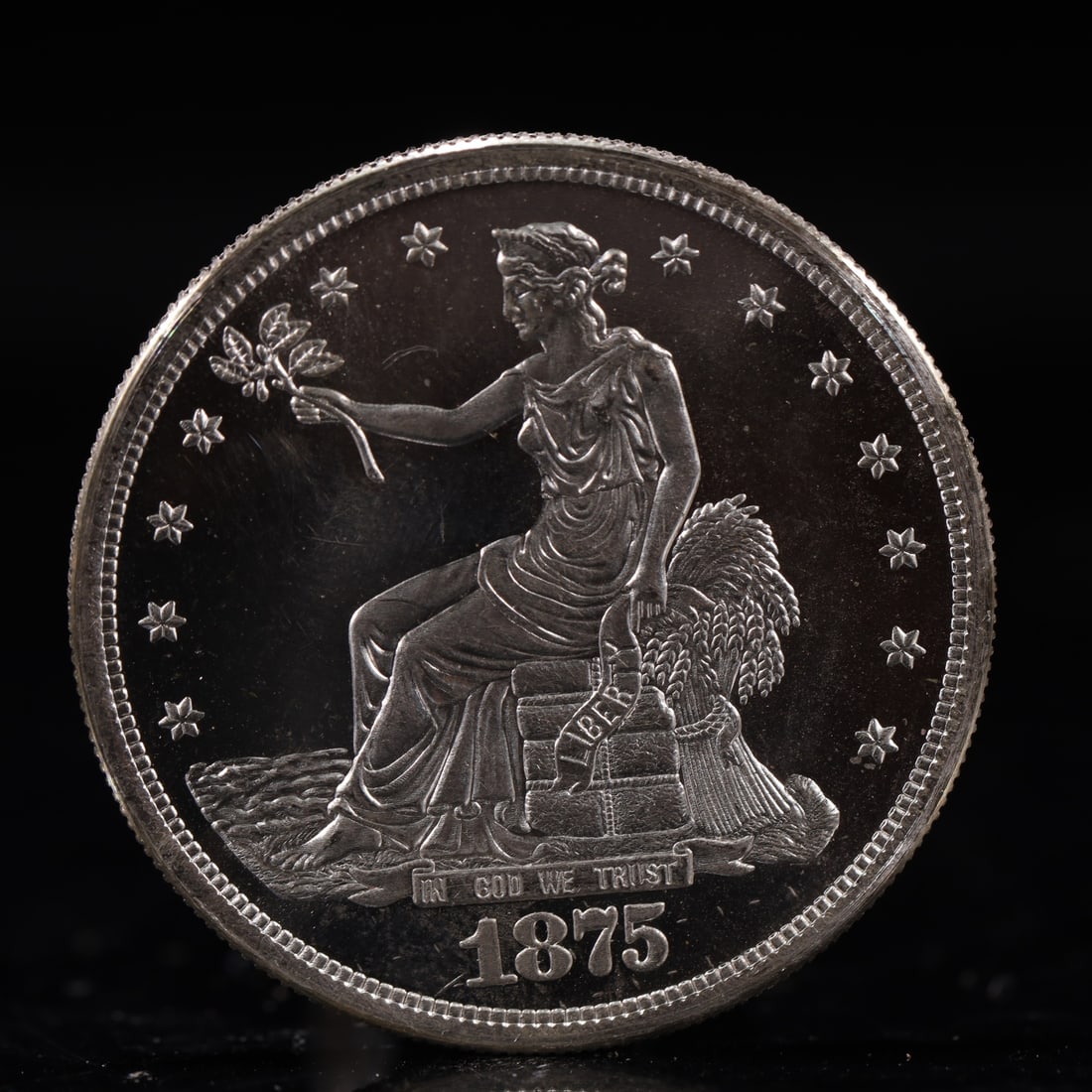 USA Trade Dollar 1875 Coin: American coin. Obverse: Liberty seated on a pedestal facing the sea to the left holding olive branches surrounded by 13 stars. IN GOD WE TRUST / LIBERTY / 1875. Reverse: An eagle holding branches with