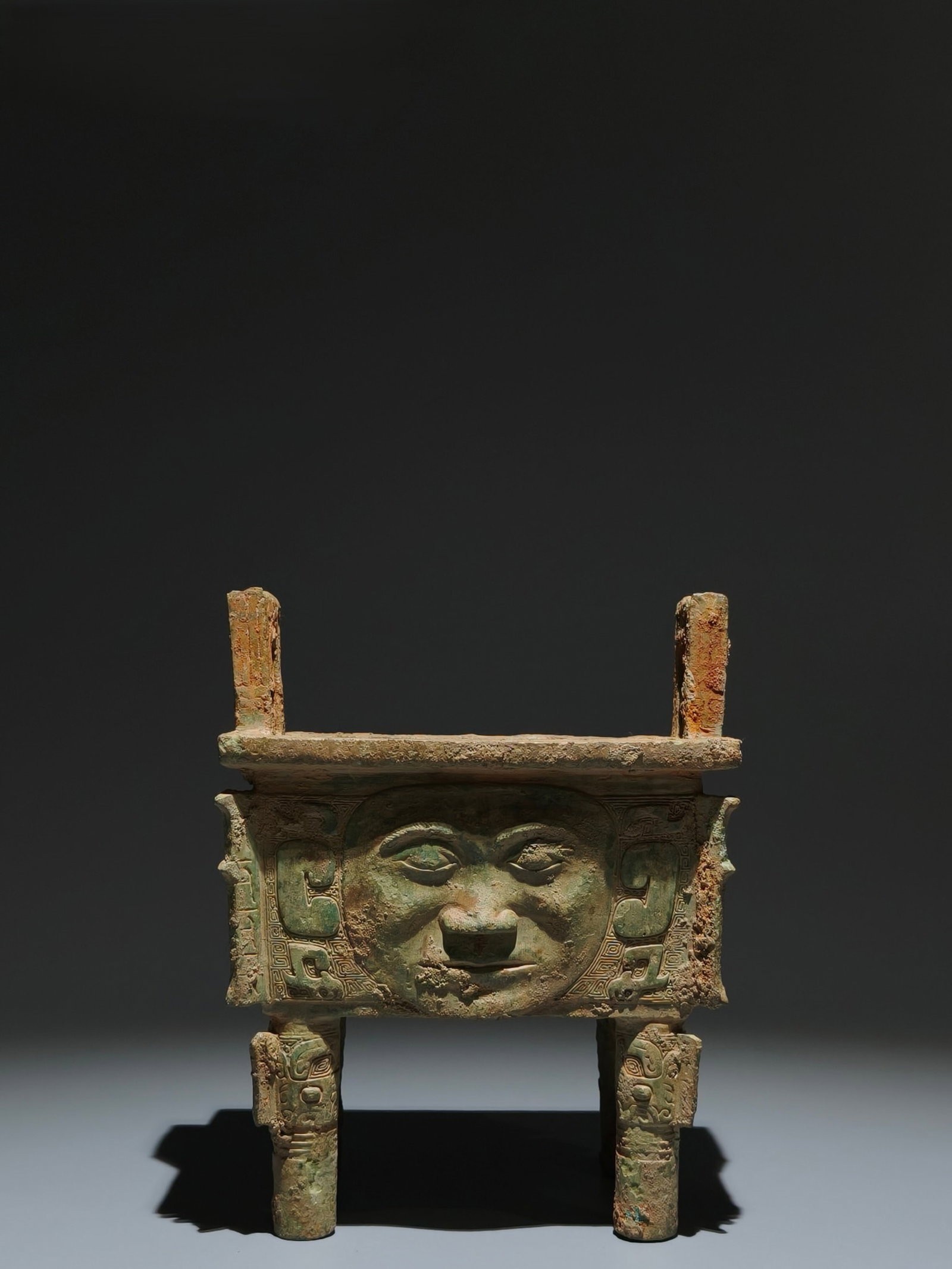 An Archaic Bronze Figure-Face Pattern Double-Ears Censer: An Archaic Bronze Figure-Face Pattern Double-Ears Censer,Shang Dynasty,China,Size:7.1inx5.5inx4.7in