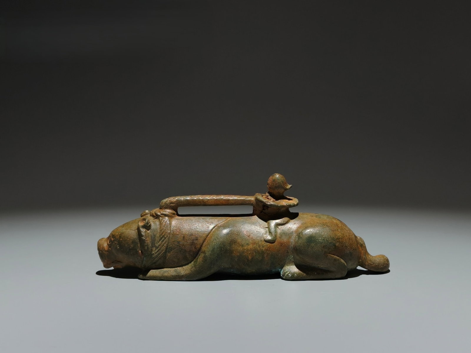 An Archaic Bronze Beast Ornament: An Archaic Bronze Beast Ornament,the Warring States period in China,Size:2.8inx7.9inx2in 青铜兽摆件,中国战国时期