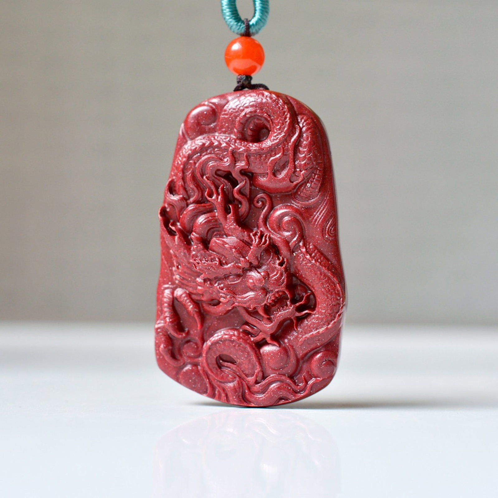 An Exquisite Cinnabar Dragon Pattern Pendant: An Exquisite Cinnabar Dragon Pattern Pendant,Size:1inx1.6in,Weight:16.8g 朱砂龙纹挂件