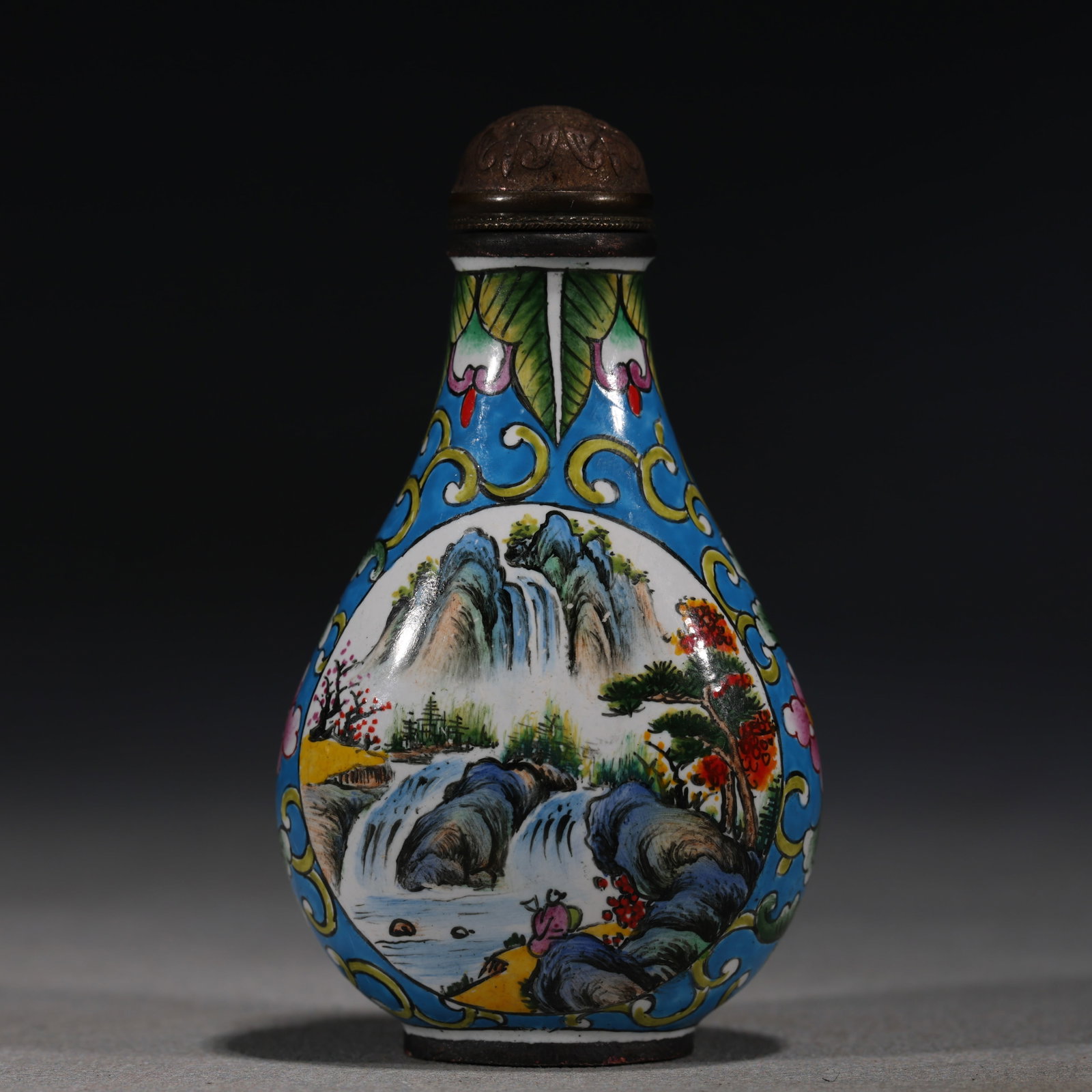 A Chinese Yellow-Ground Painted Enamel Snuff Bottle with Birds and Grapes,Qianlong Mark: A Chinese yellow-ground painted enamel snuff bottle,decorated with two colorful birds fluttering around grapevines.Fitted with a red stopper.The base bears a four-character mark reading(Qianlong Nian 