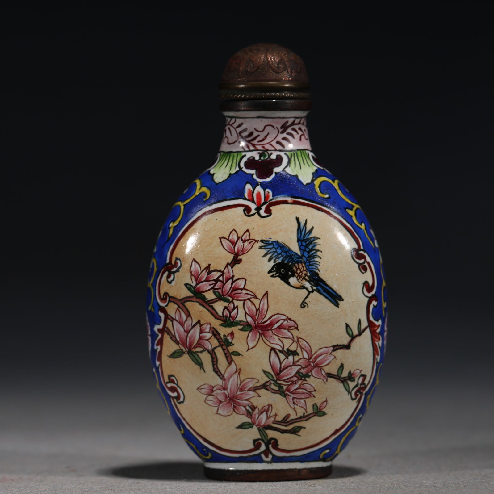 A Chinese Yellow-Ground Painted Enamel Snuff Bottle with Bird and Peony,Qianlong Mark: A Chinese yellow-ground painted enamel snuff bottle,painted with a bird perched on rockwork amidst blooming peonies.Fitted with a bronze stopper.The base bears a four-character mark reading(Qianlong