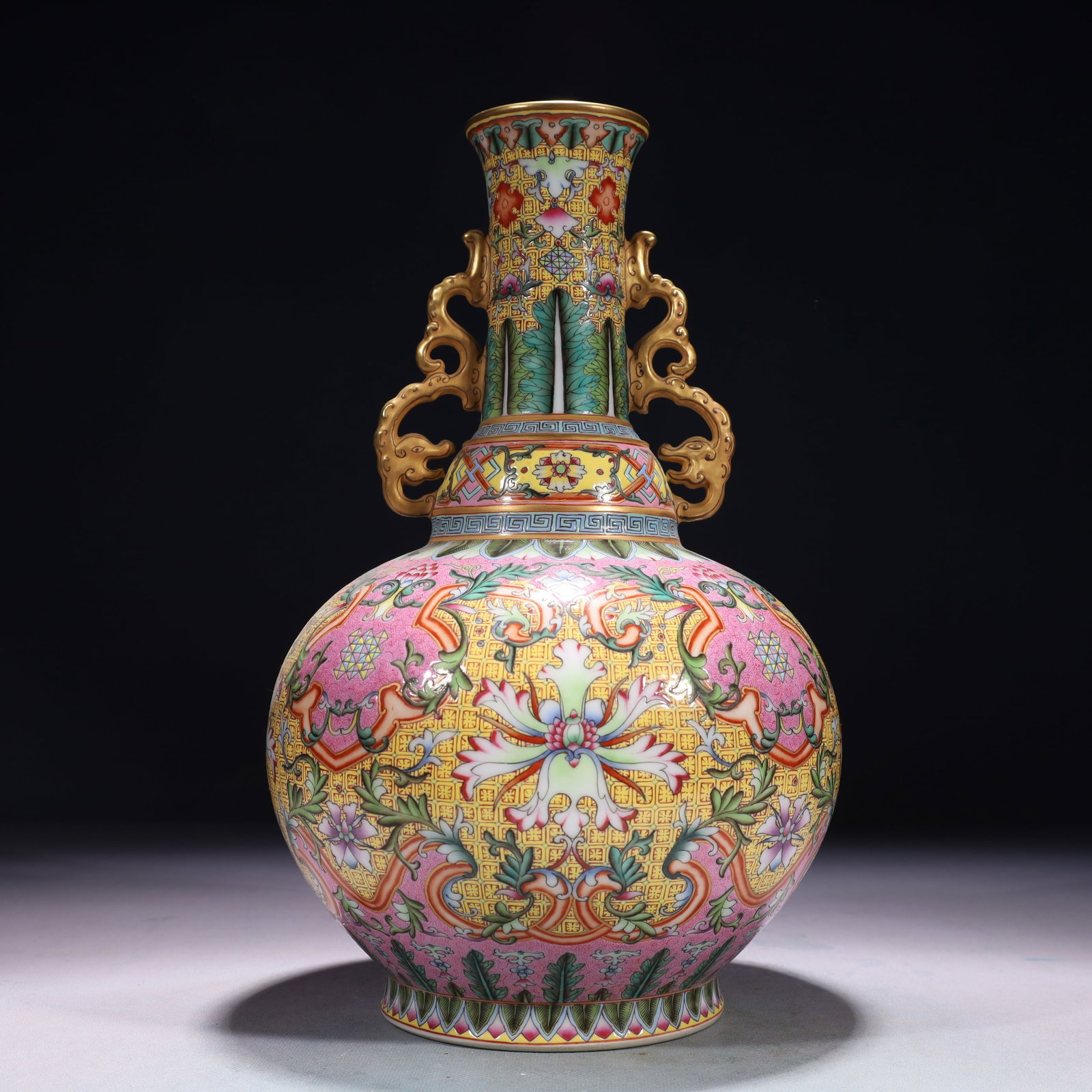 An Exquisite Famille-Rose Painted Gold Lotus Pattern Double-Ears Vase: An Exquisite Famille-Rose Painted Gold Lotus Pattern Double-Ears Vase,Qing Dynasty,China,Qianlong Four-character Mark,Size:7.5inx12.6in,Weight:2050g 粉彩描金缠枝
