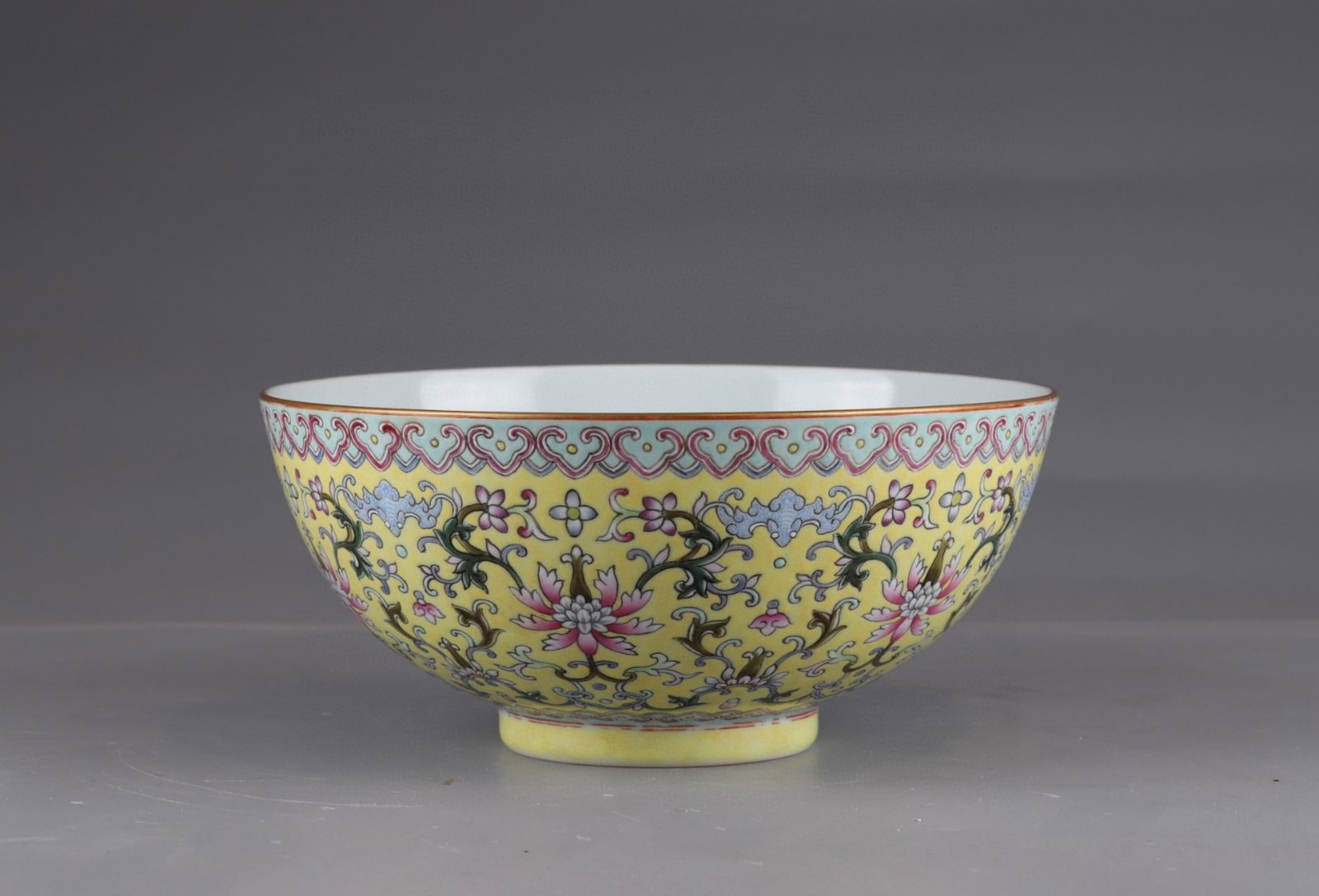 An Exquisite Yellow Ground Famille-Rose Lotus Pattern Bowl: An Exquisite Yellow Ground Famille-Rose Lotus Pattern Bowl,Qing Dynasty,China,Qianlong Six-character Mark,Size:4.1inx8.9in 黄地粉彩缠枝莲纹碗,
