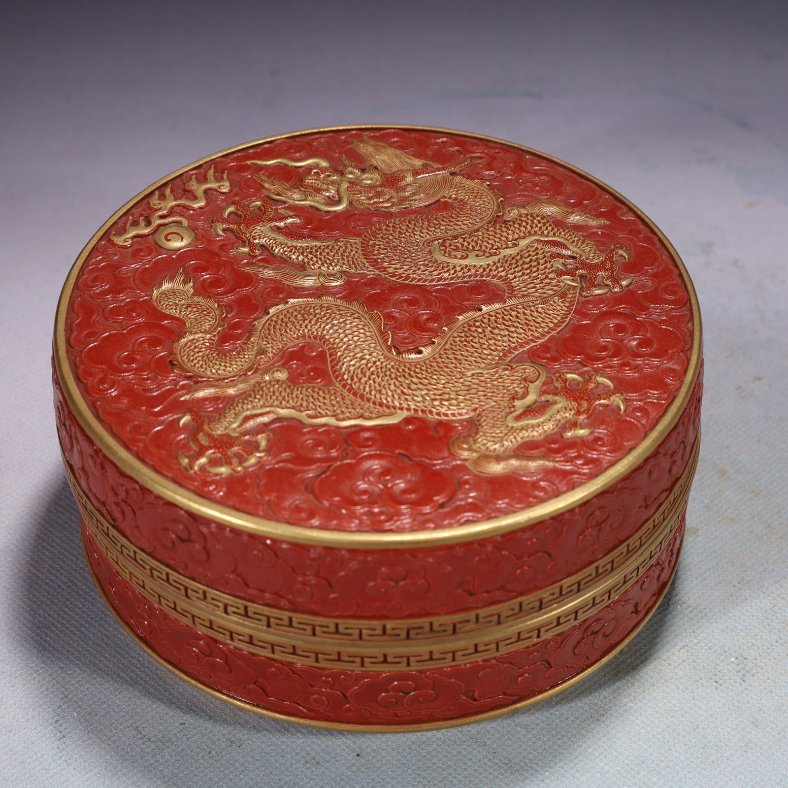 An Exquisite Red Glazed Painted Gold Auspicious Cloud and Dragon Pattern Box with Cover: An Exquisite Red Glazed Painted Gold Auspicious Cloud and Dragon Pattern Box with Cover,Qing Dynasty,China,Qianlong Six-character Mark,Size:5.9inx2.8in,Weight:1050g