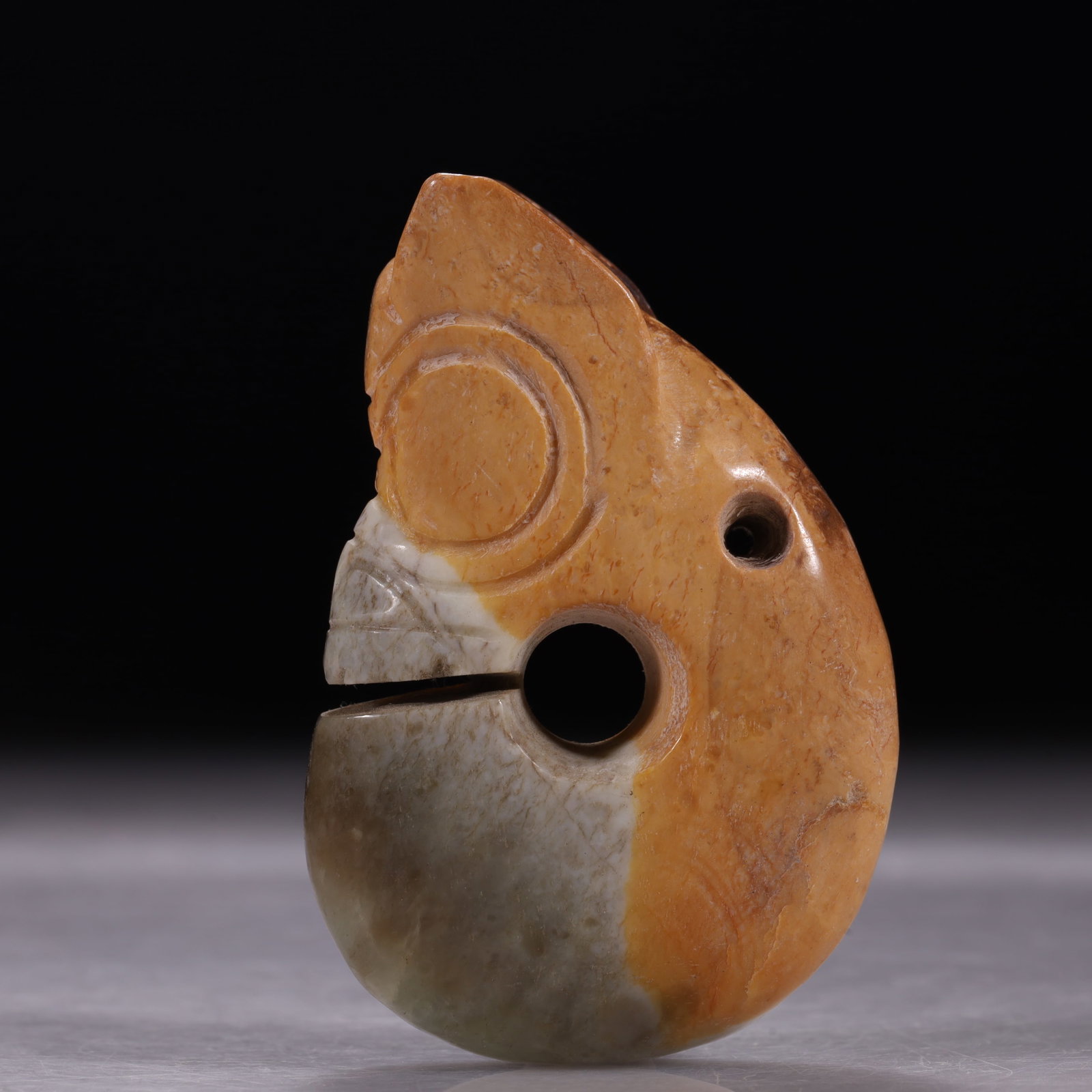 Hongshan Culture Red-Brown Jade Coiled Pig-Dragon With Large Perforation And Ears: Classic C-shaped coiled pig-dragon. Characterized by a large head, upright ears, wrinkles carved on the nose bridge, and a large central hole without a complete cut at the mouth. The jade is fully sta