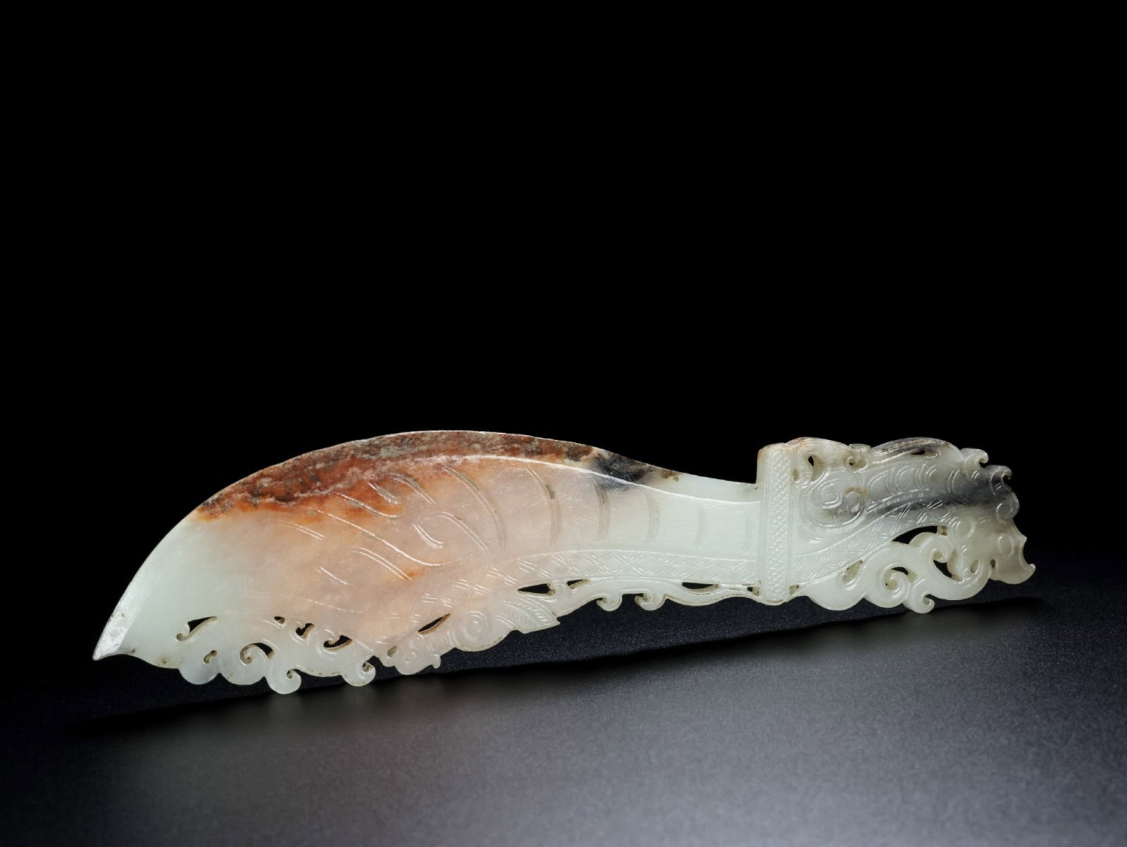 An Exquisite White Jade Auspicious Beast Pattern Sword: An Exquisite White Jade Auspicious Beast Pattern Sword,Qing Dynasty,China,Size:8.6inx2.2inx0.2in,Weight:127.6g 白玉瑞兽纹刀,中国清代