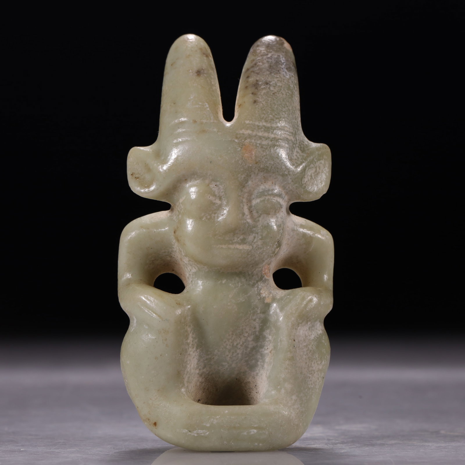 Hongshan Culture Celadon-White Jade Arched Pendant with Double Beast Heads: Celadon-white jade with greyish-white and brown alterations on the surface. The object is bridge-shaped, with abstract beast heads carved on both ends and openwork carving in the center, featuring a u