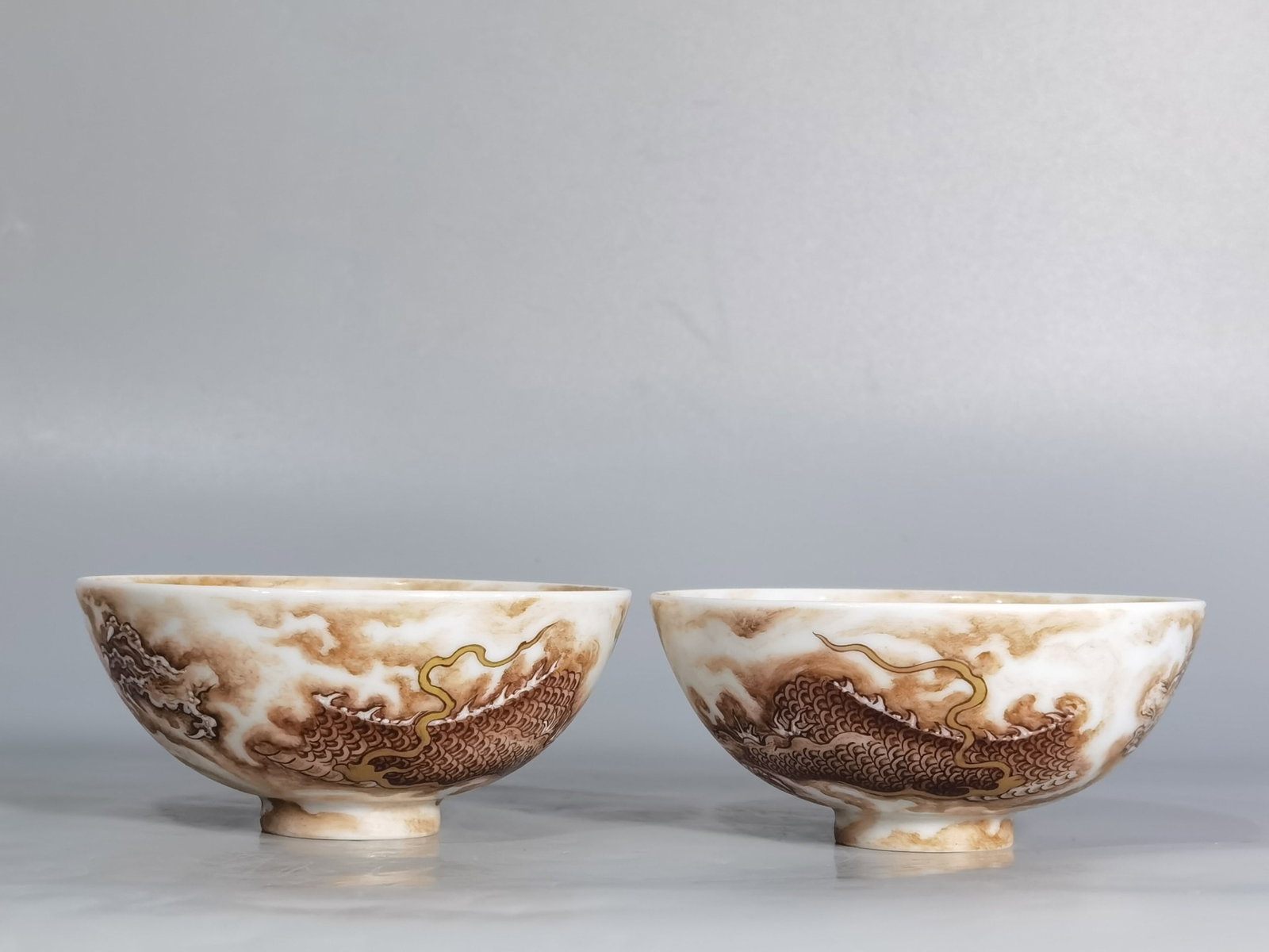 A Pair of Exquisite Ink Color Auspicious Cloud and Dragon Pattern Cups: A Pair of Exquisite Ink Color Auspicious Cloud and Dragon Pattern Cups,Qing Dynasty,China,Kangxi Six-character Mark,Size:3.5inx1.5in 一对墨彩祥云龙纹