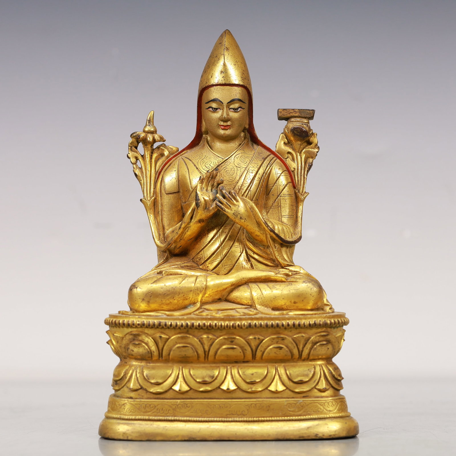 An Excellent Gilt-Bronze Figure Of Tsongkapa: An Excellent Gilt-Bronze Figure Of Tsongkapa. The figure with a dignified expression is rendered clad in long,flowing robes,the voluminous drapery elegantly cascading in folds,topknot surmounted by a 