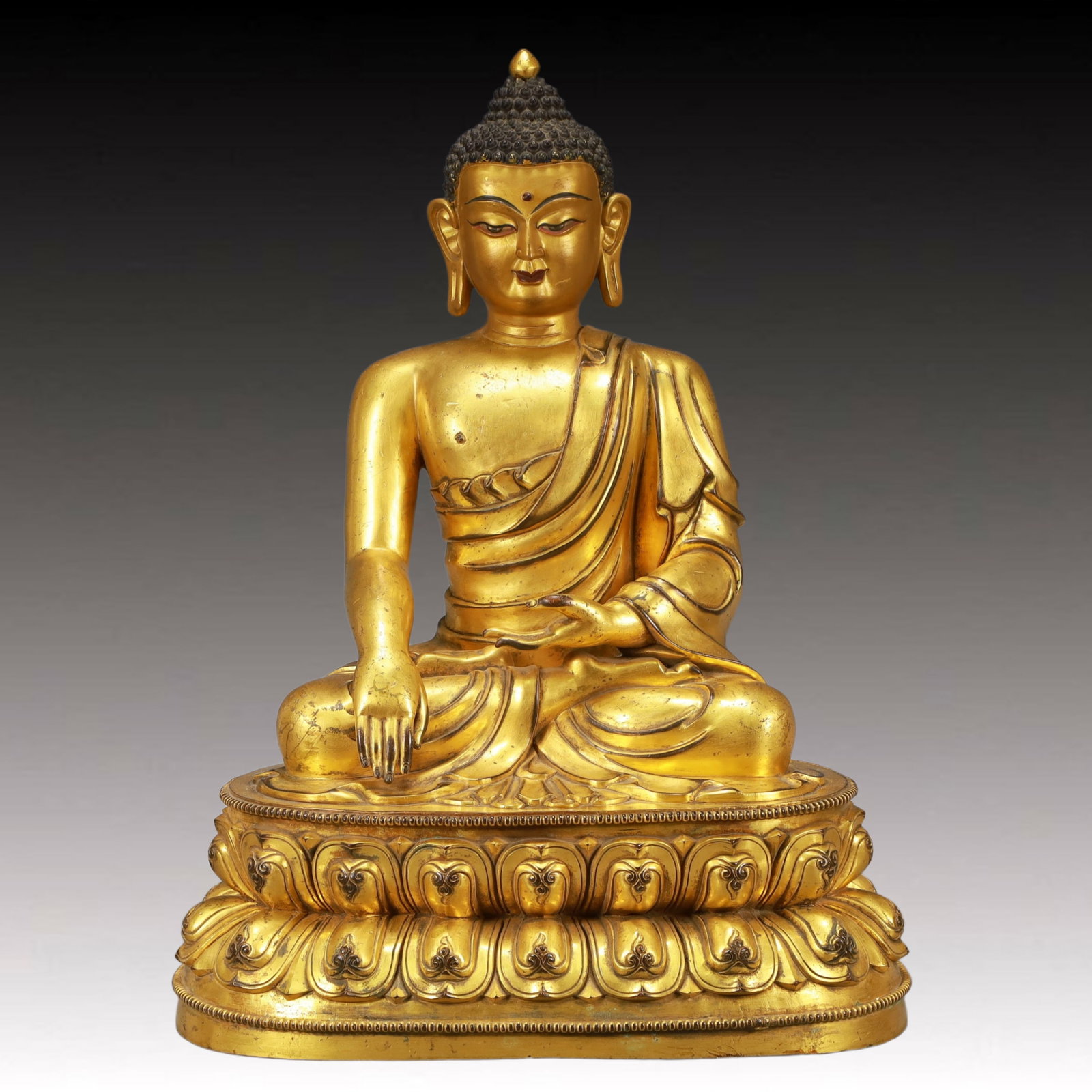 A Solemn Gilt Bronze Statue of Sakyamuni: A Solemn Gilt Bronze Statue of Sakyamuni,Qing Dynasty, China,Kangxi Seven-character Mark,Size:14.6inx10.2inx19.7in,Weight:19950g 铜鎏金释迦摩尼像,ߑ